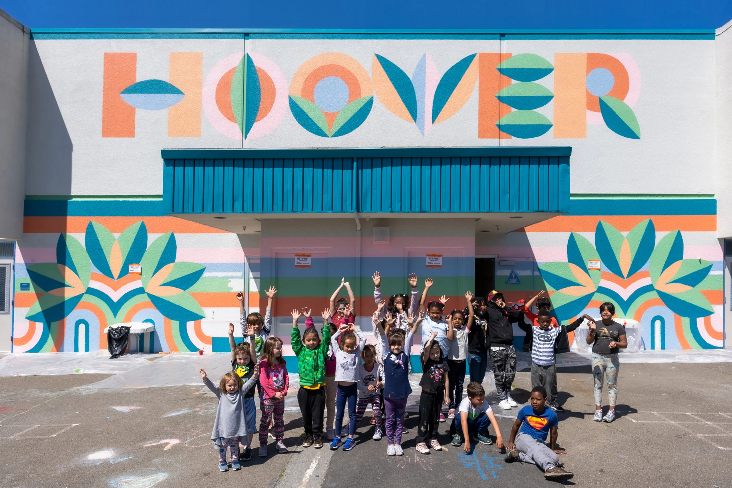 Students in front of a mural they painted with Project Color Corps in Oakland California.