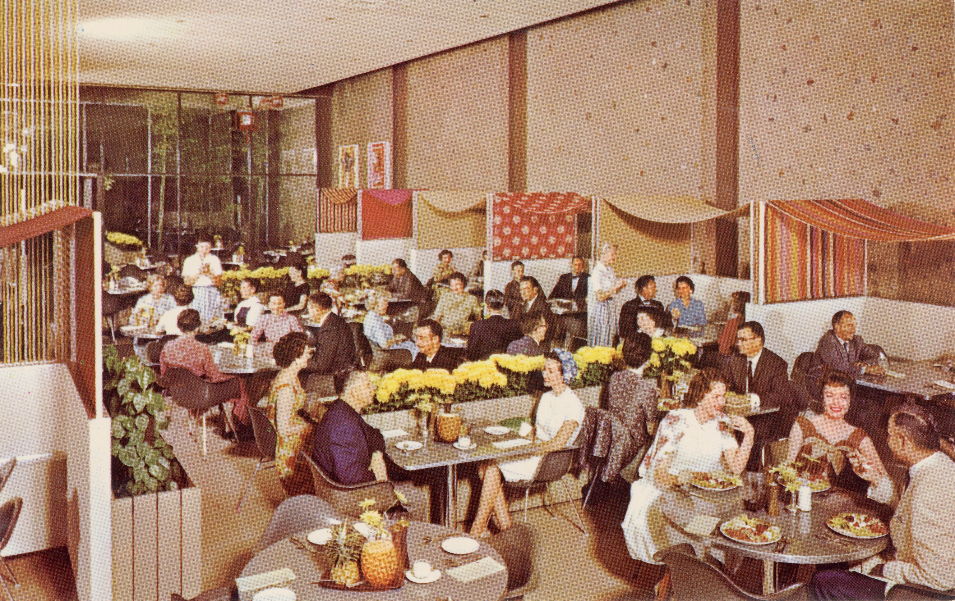 Postcard featuring the dining room of The Nut Tree filled with Eames chairs, Alexander Girard draped textiles, and patrons.