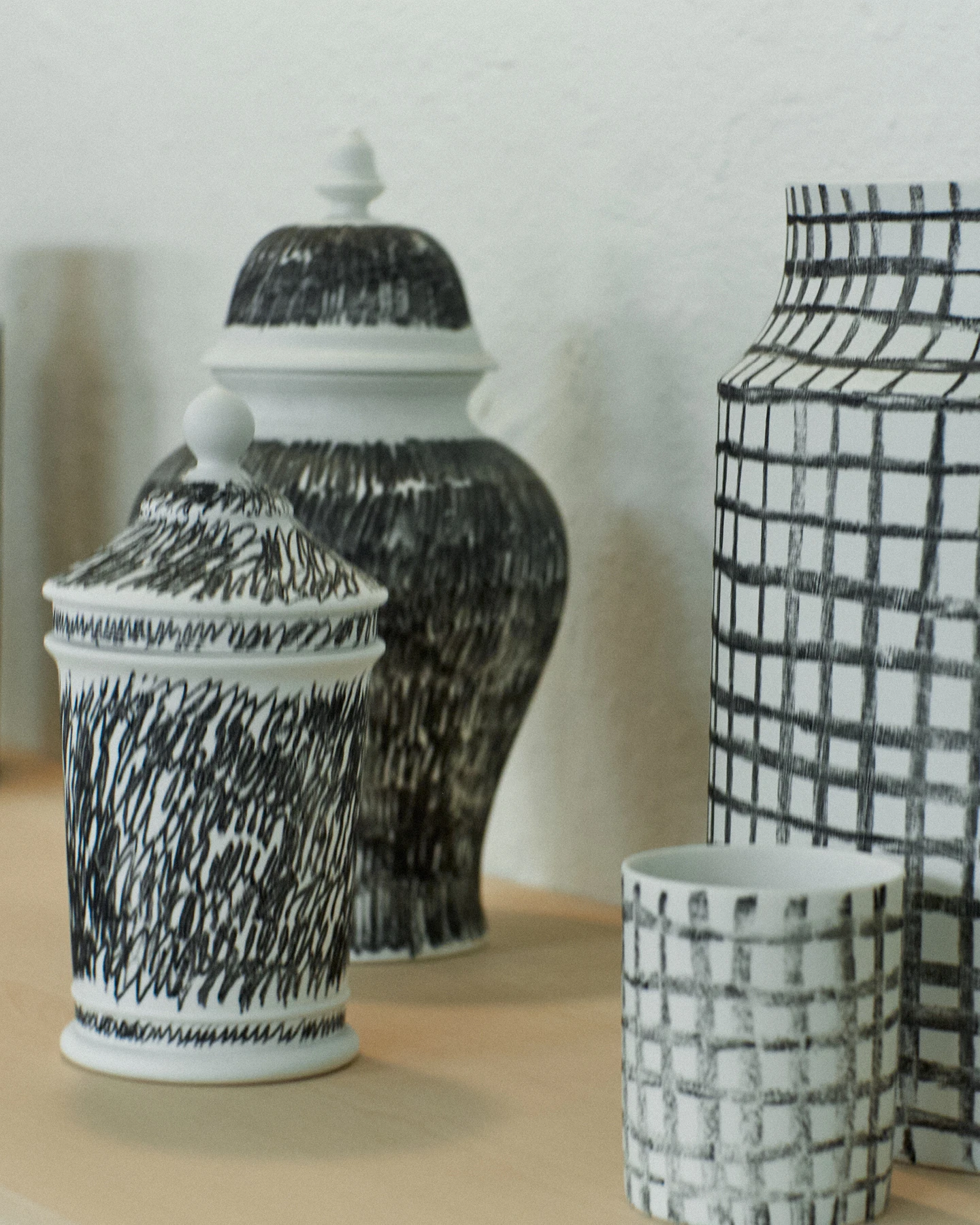 Several black and white porcelain pieces designed by design studio Formfantasma on a table top.