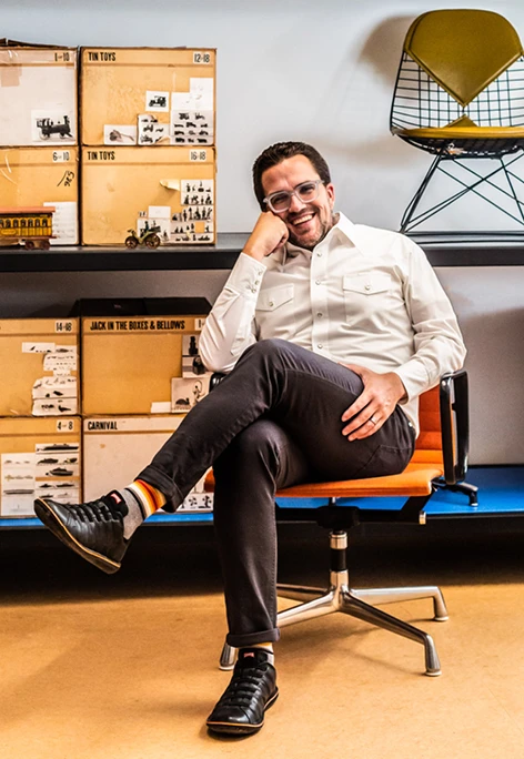 John Cary, president and CEO of the Eames Institute, sitting in an Eames chair at the Eames Ranch.