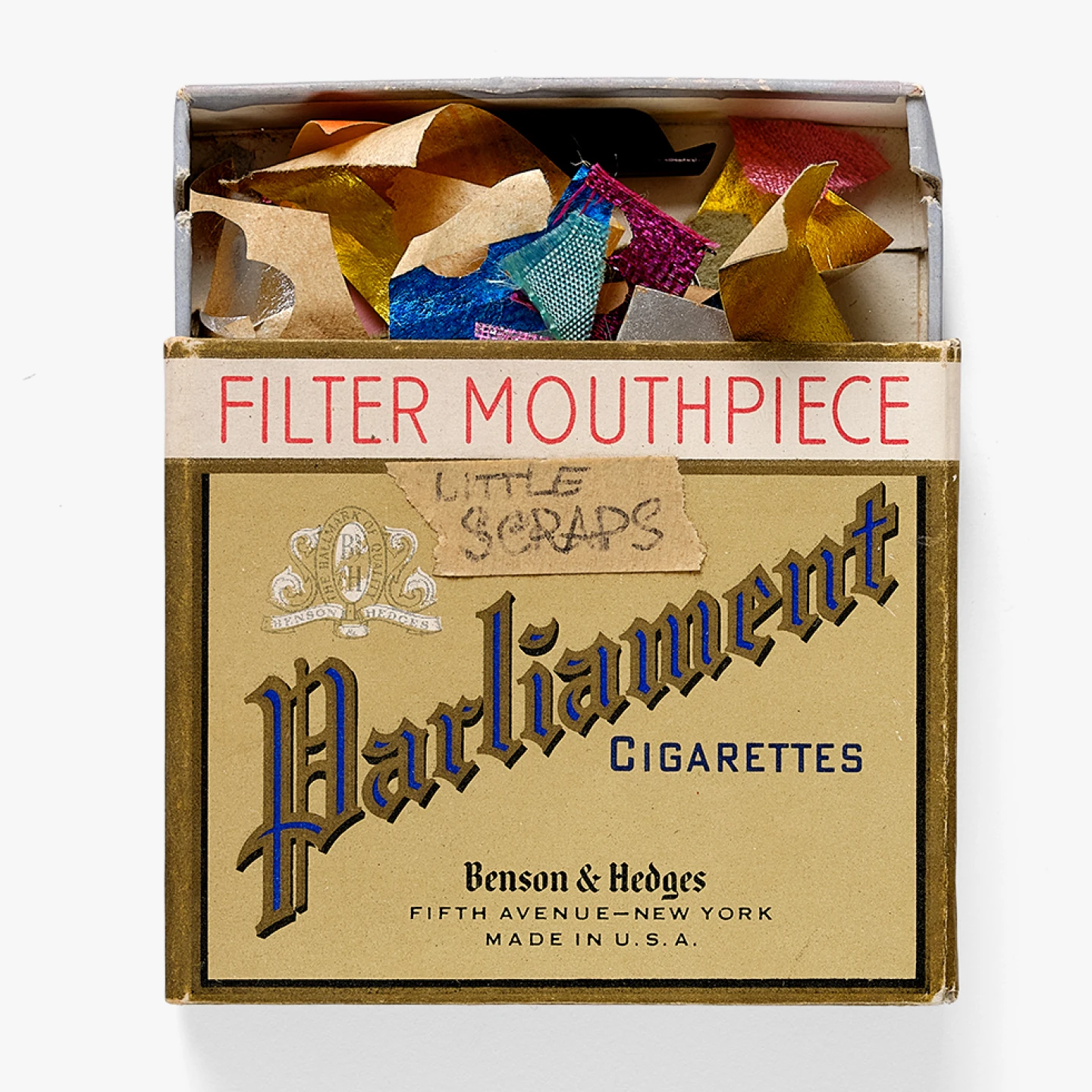 Package labeled “Little Scraps” from the Eames Office graphics room contains colorful pieces of paper and textiles.