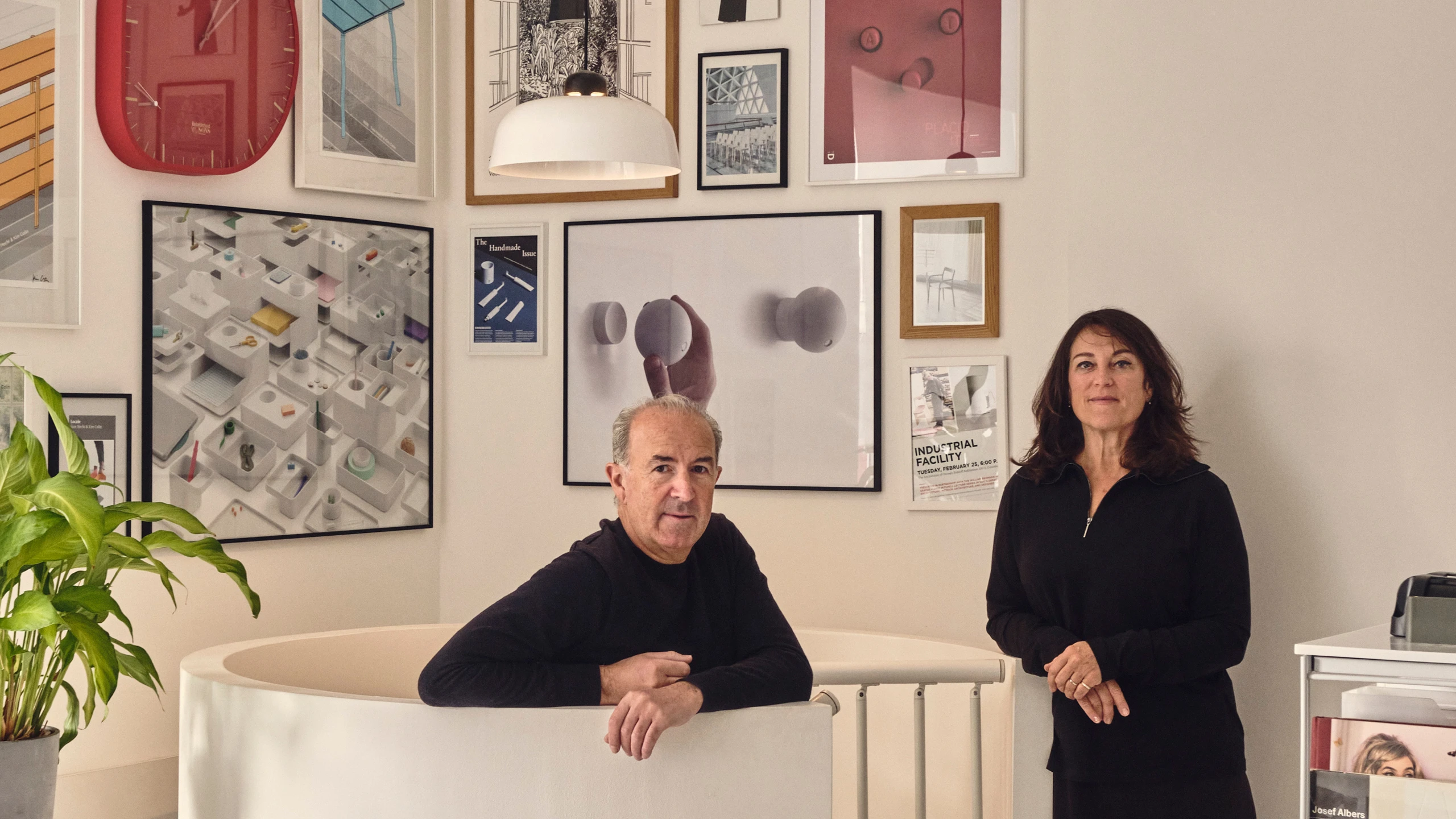 Designers Sam Hecht and Kim Colin of Industrial Facility in their studio surrounded by posters of their work—Kazam! Magazine.
