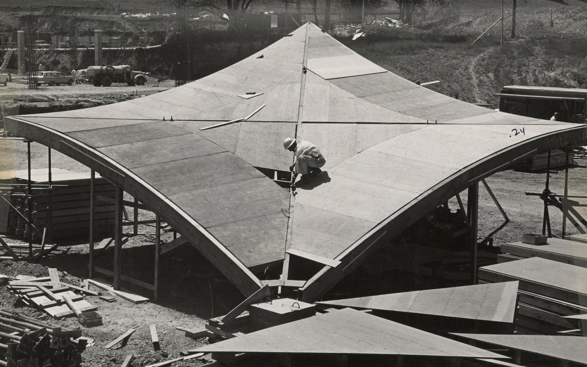 Black and white image of a construction worker on a section hyperbolic parabaloid roofing
