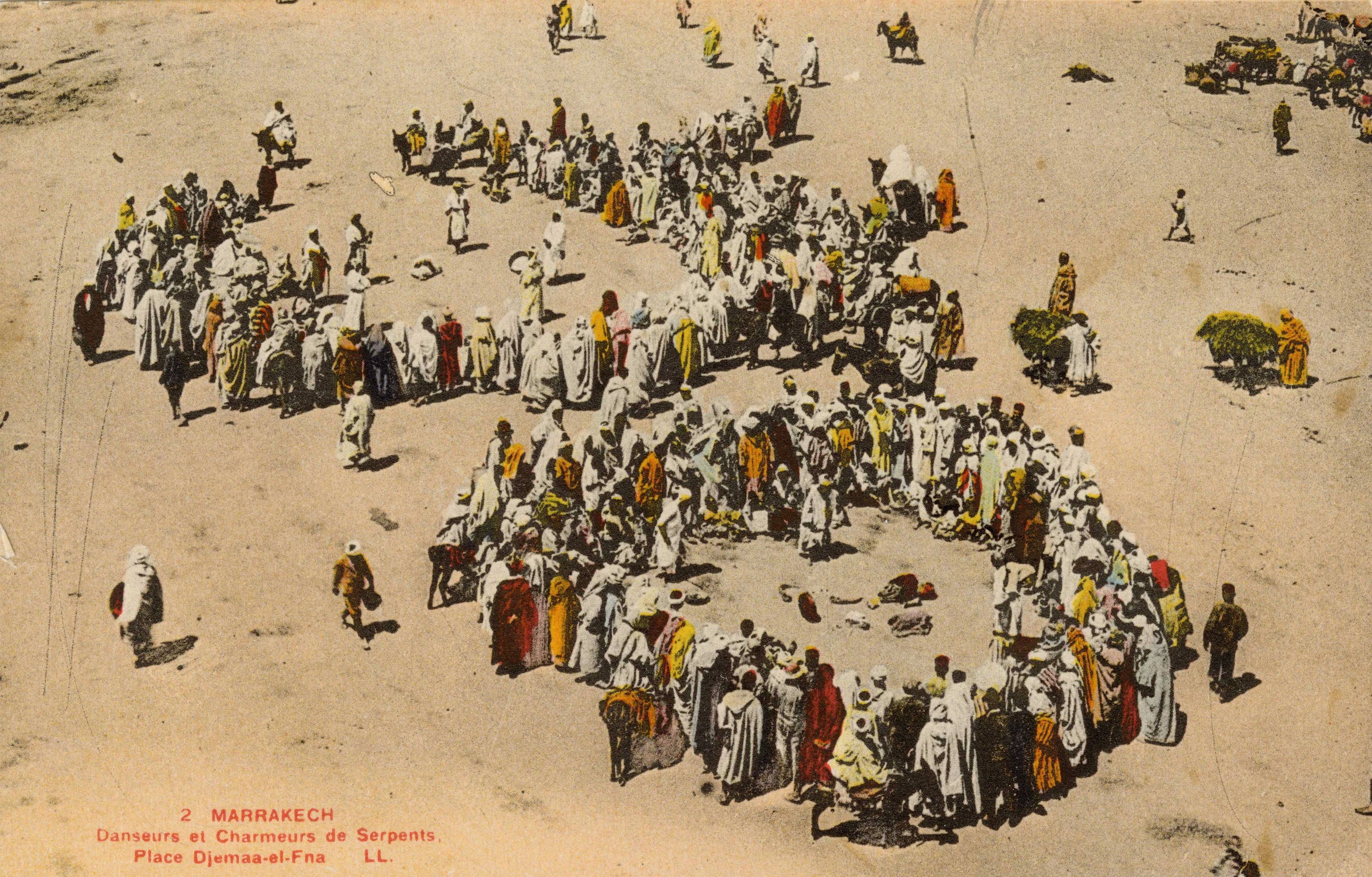 French postcard circa 1940, featuring a scene of dancers and snake charmers in Djemaa el-Fnaa, in Marrakesh, Morocco.