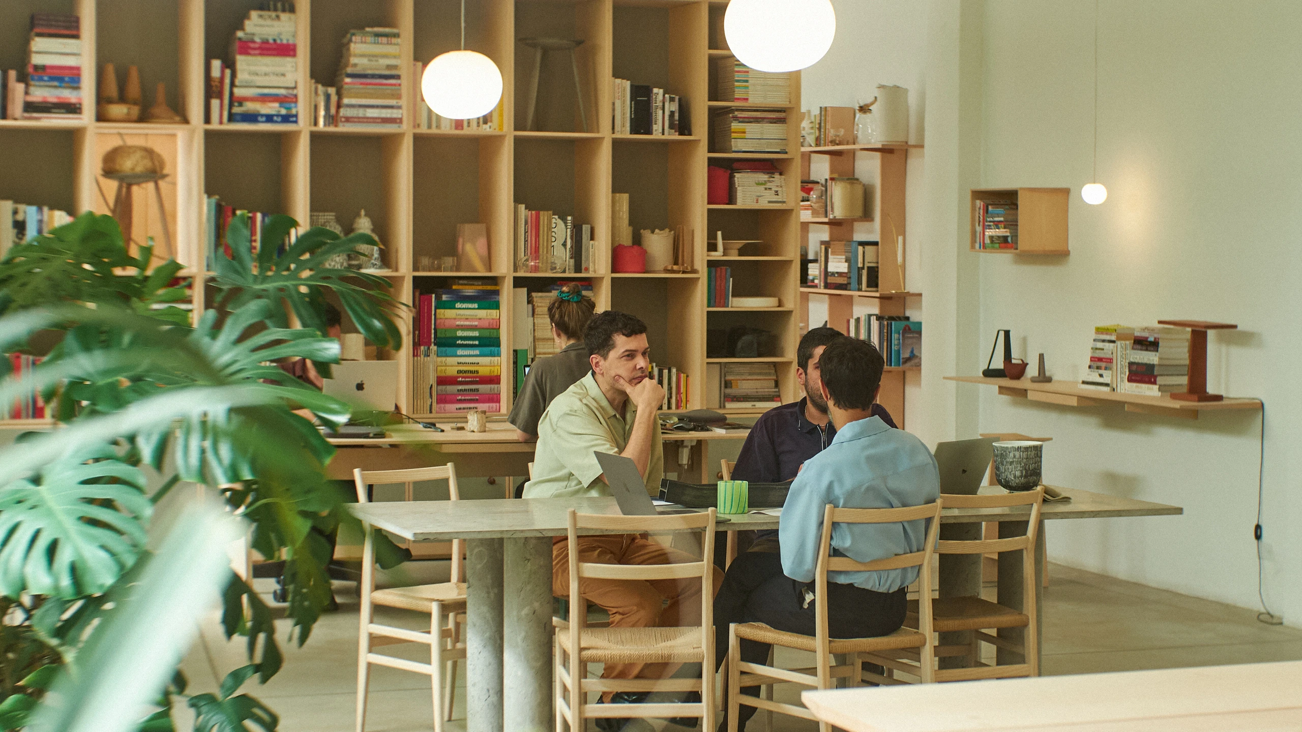 Andrea Trimarchi and Simone Farresin working at a table in their design studio Formafantasma.