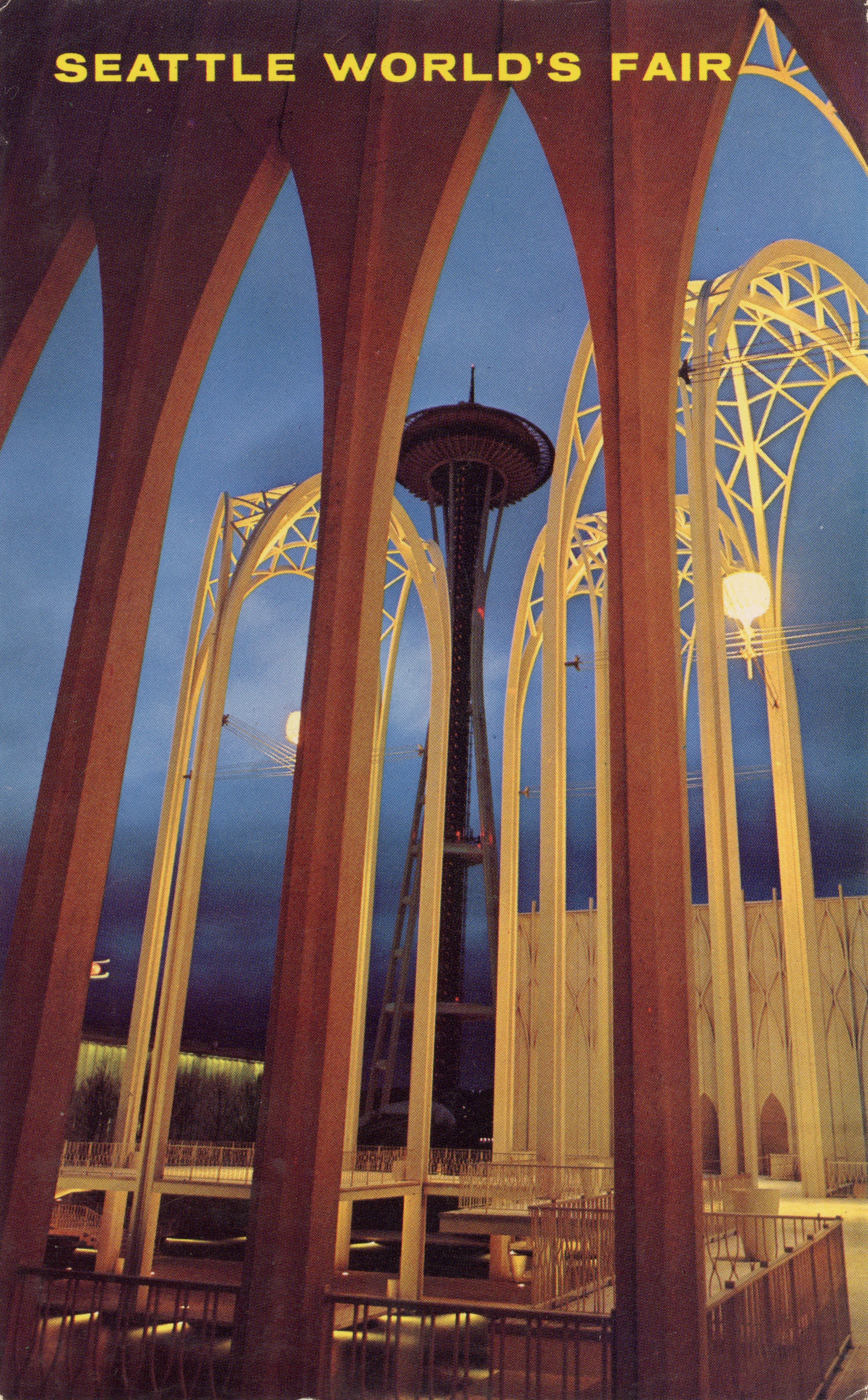 1962 Seattle World’s Fair postcard with a view of the Space Needle through the arches of the Science Pavilion.
