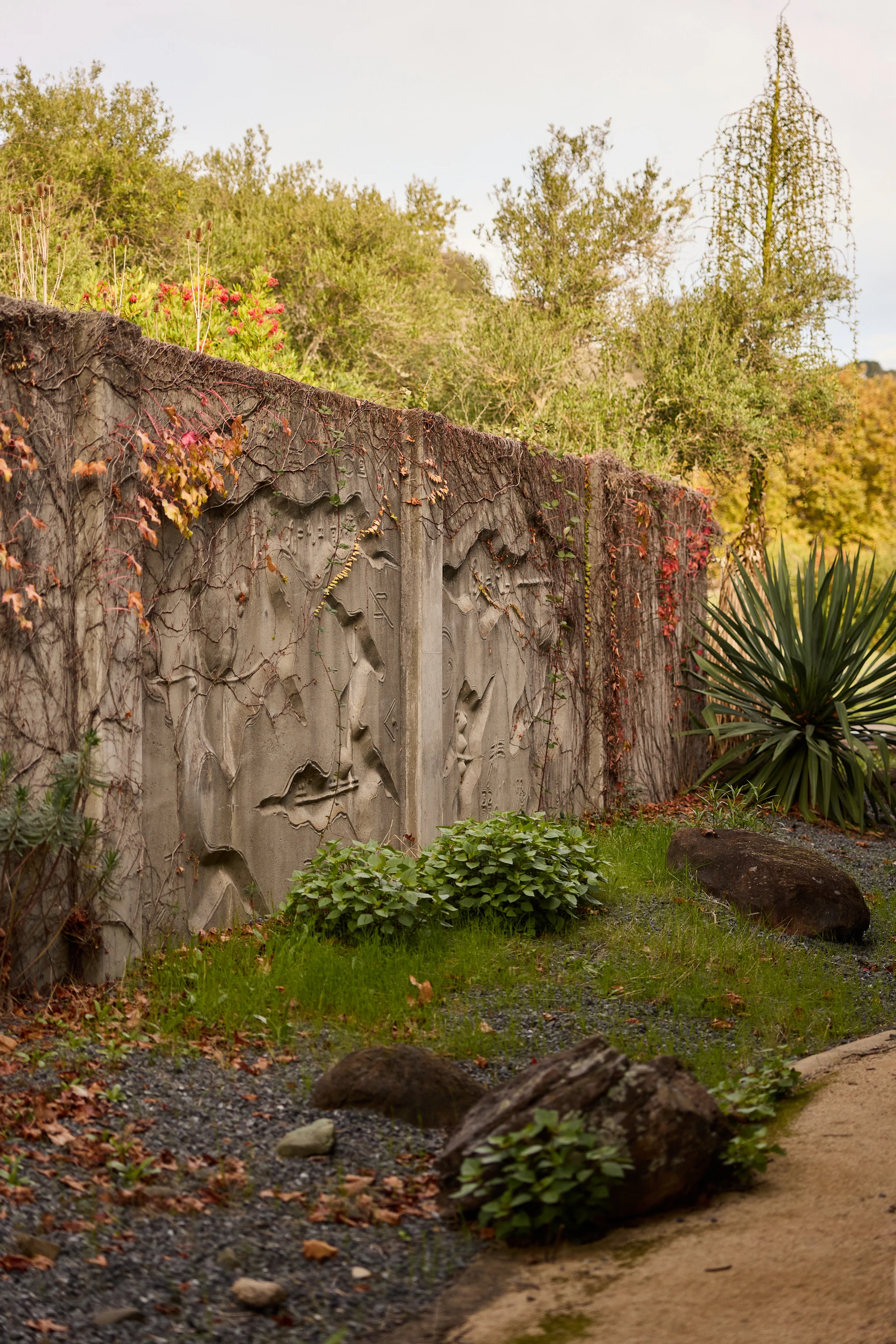 Cropped view of of a concrete relief mural by artist Gurdon Woods.
