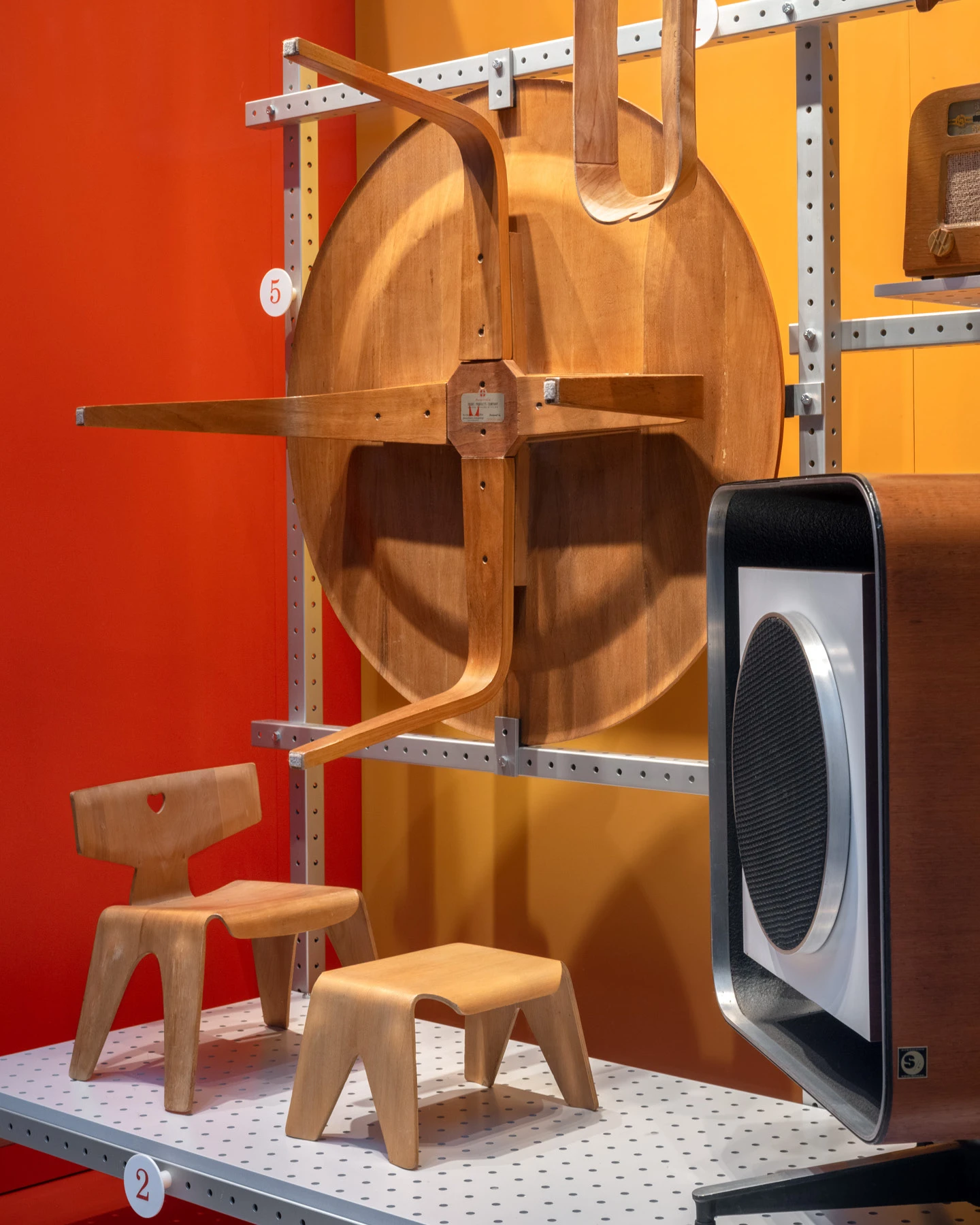 Early example of the Eames Child’s Chair and Stool shows a variation in the leg cut-outs, while a 1947 CTW (coffee table wood) bears a hybrid Evans Products/Herman Miller label.