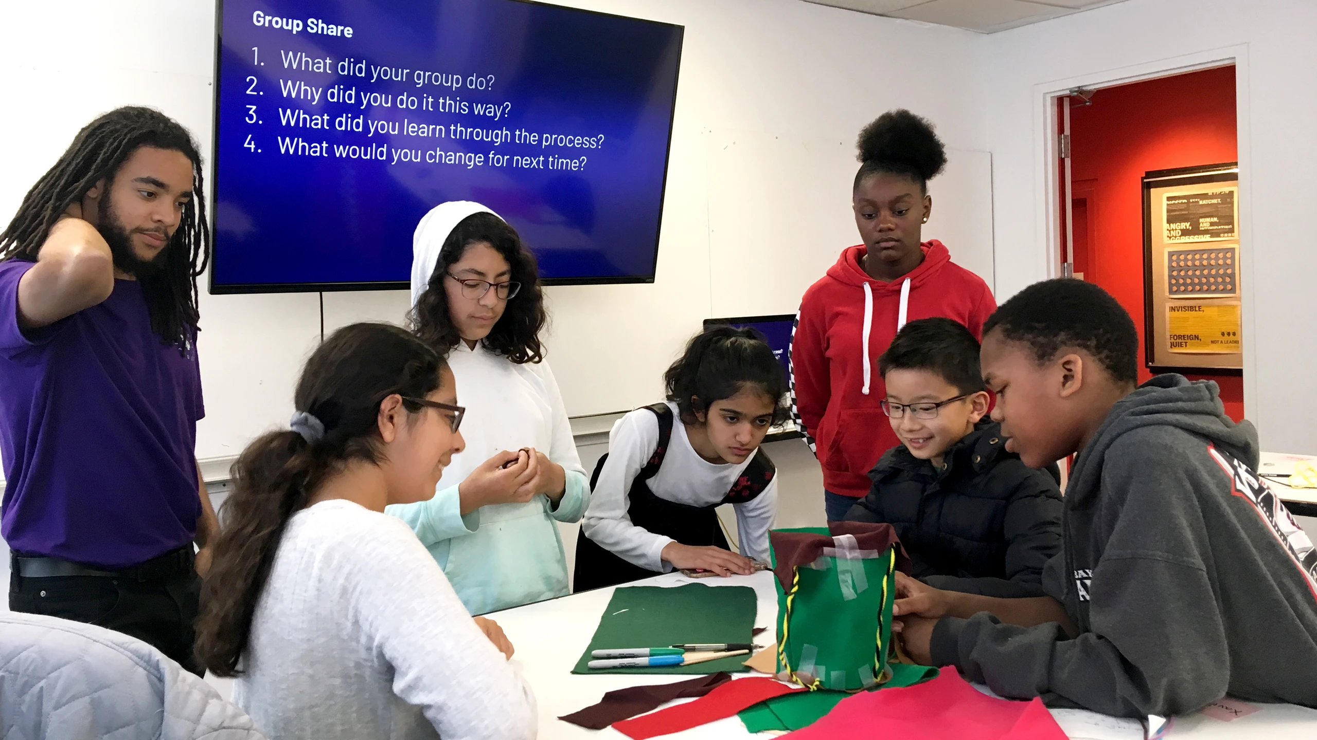 Students work on an Inneract Project design class exercise as mentors observe.