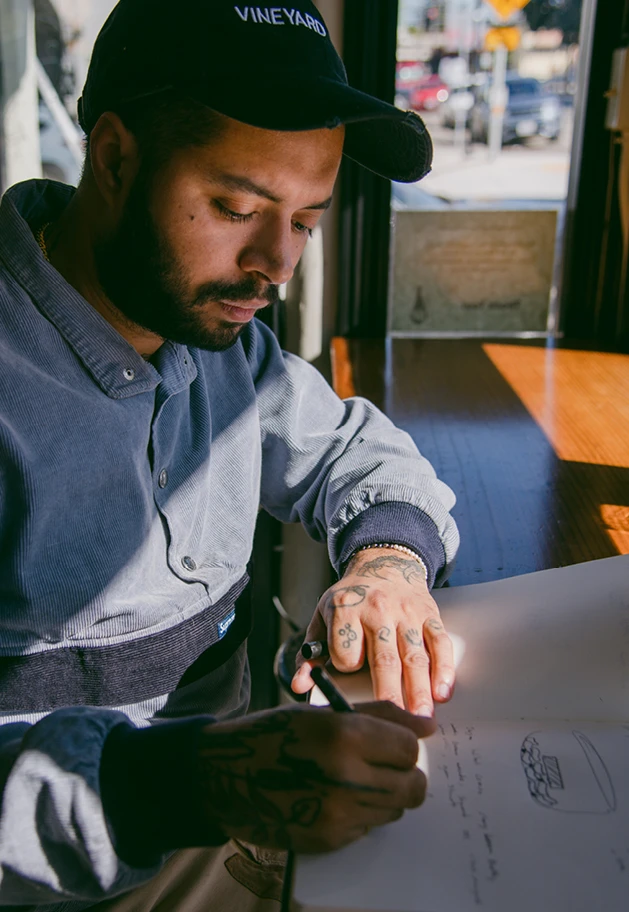 Chef and owner Andres Giraldo Florez sketching a menu at Oakland California’s Snail Bar, Kazam! Magazine.