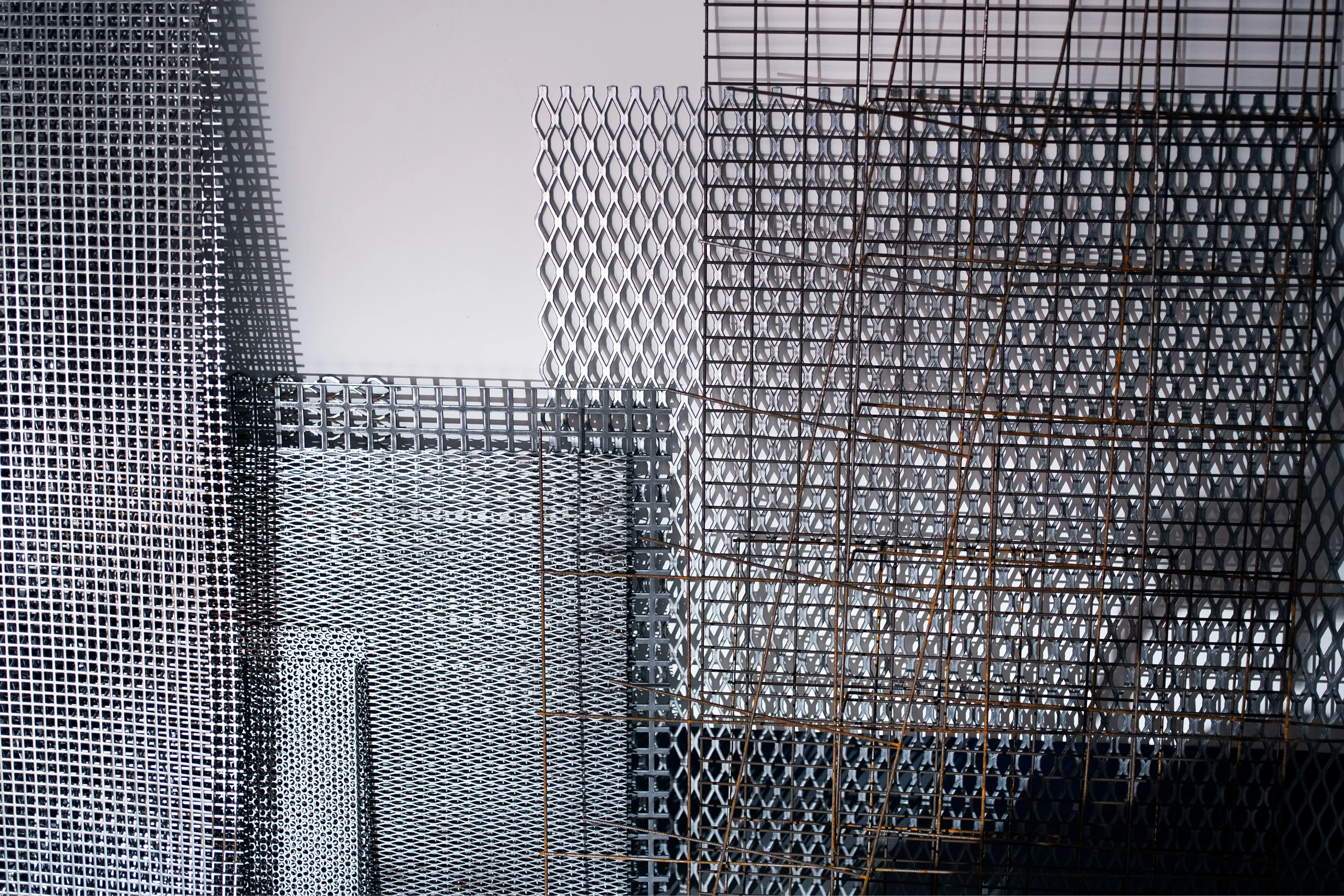 Close up of several steel sheet materials used by artist Barbara Kasten.