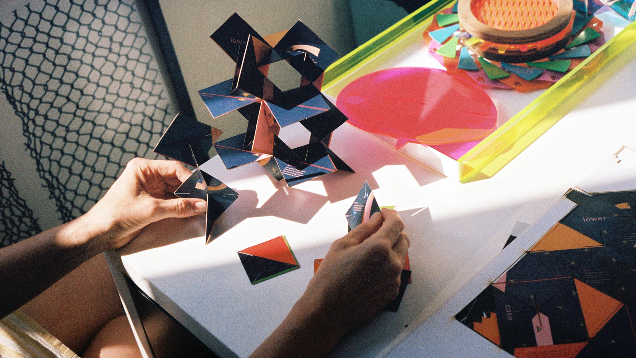 Designer and paper engineer Kelli Anderson working on a geometric shaped 3-D paper structure in her studio.
