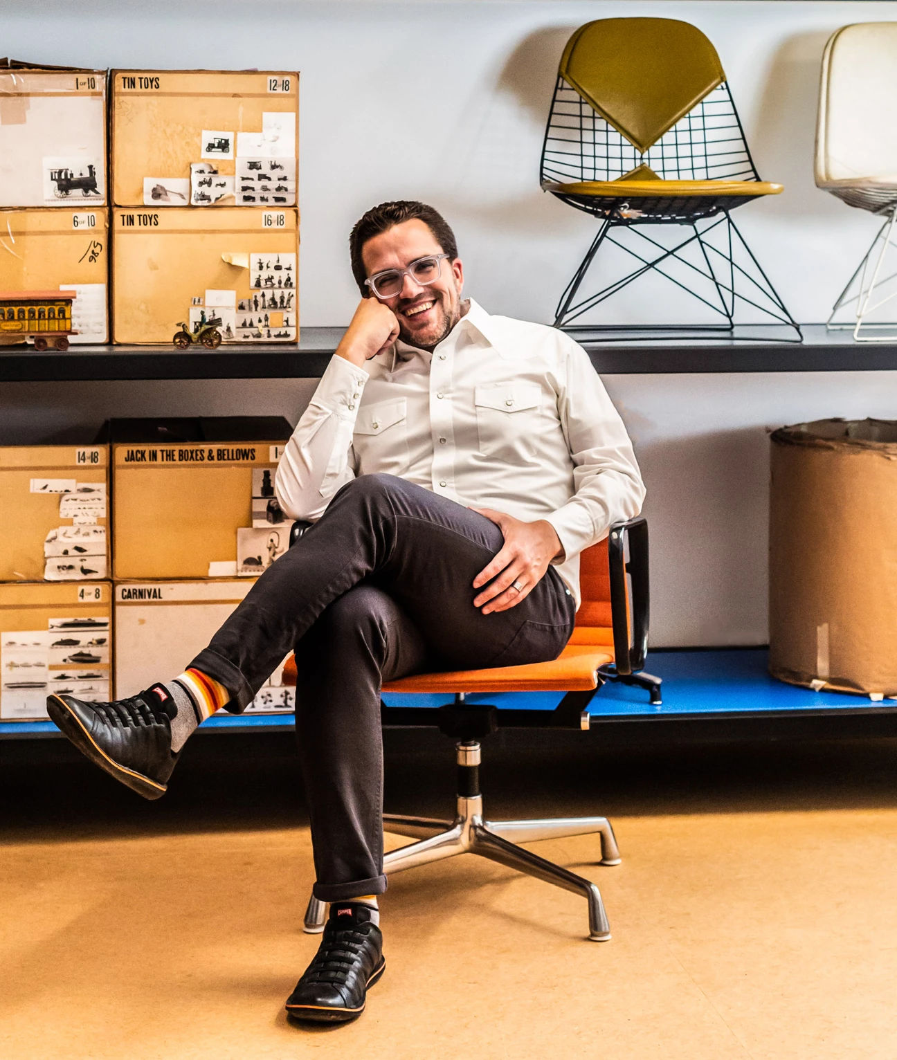John Cary, president and CEO of the Eames Institute, sitting in an Eames chair at the Eames Ranch.