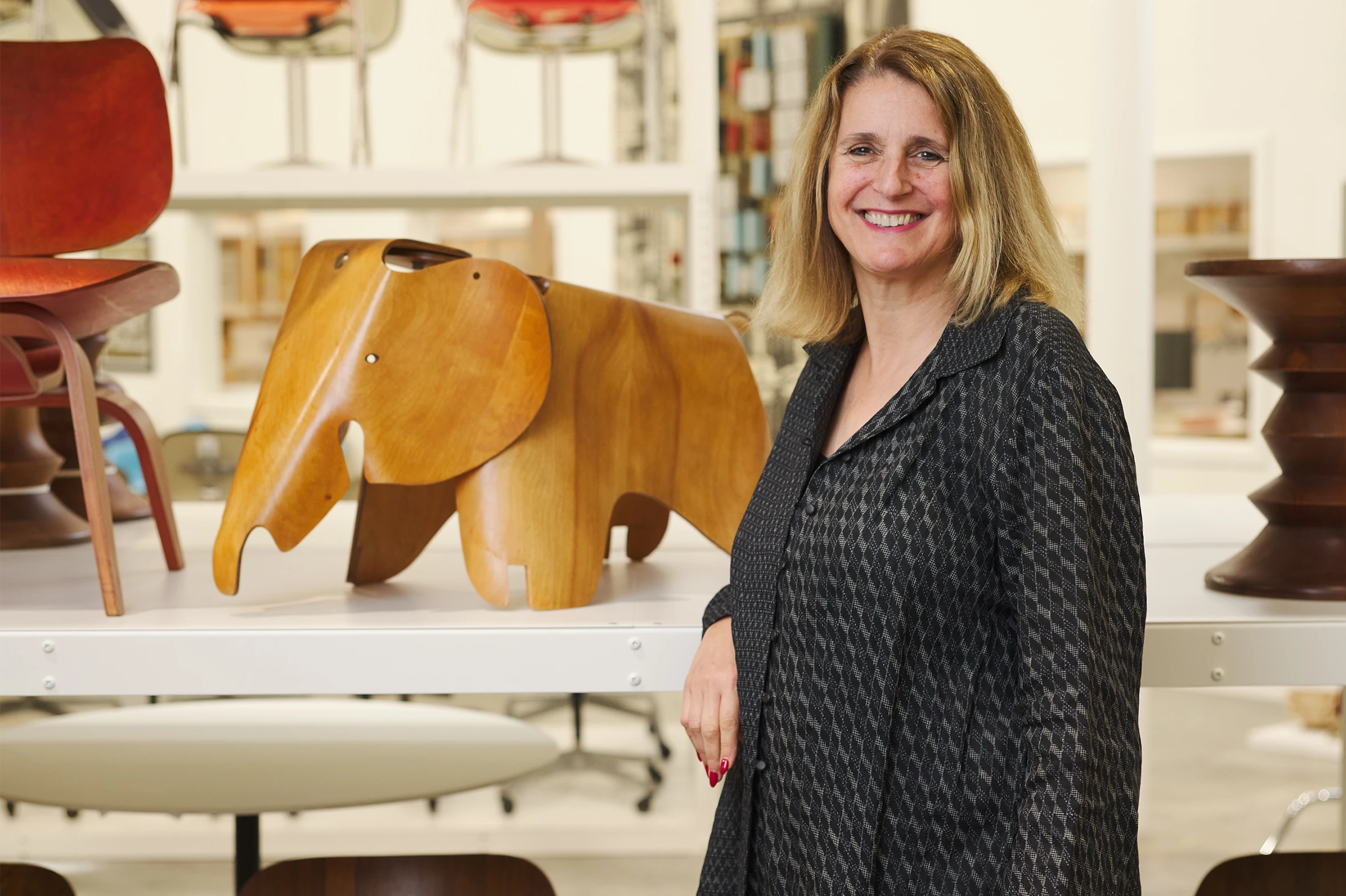Llisa Demetrios stands beside an Eames Elephant in the Eames Institute archives, where she leads private tours.