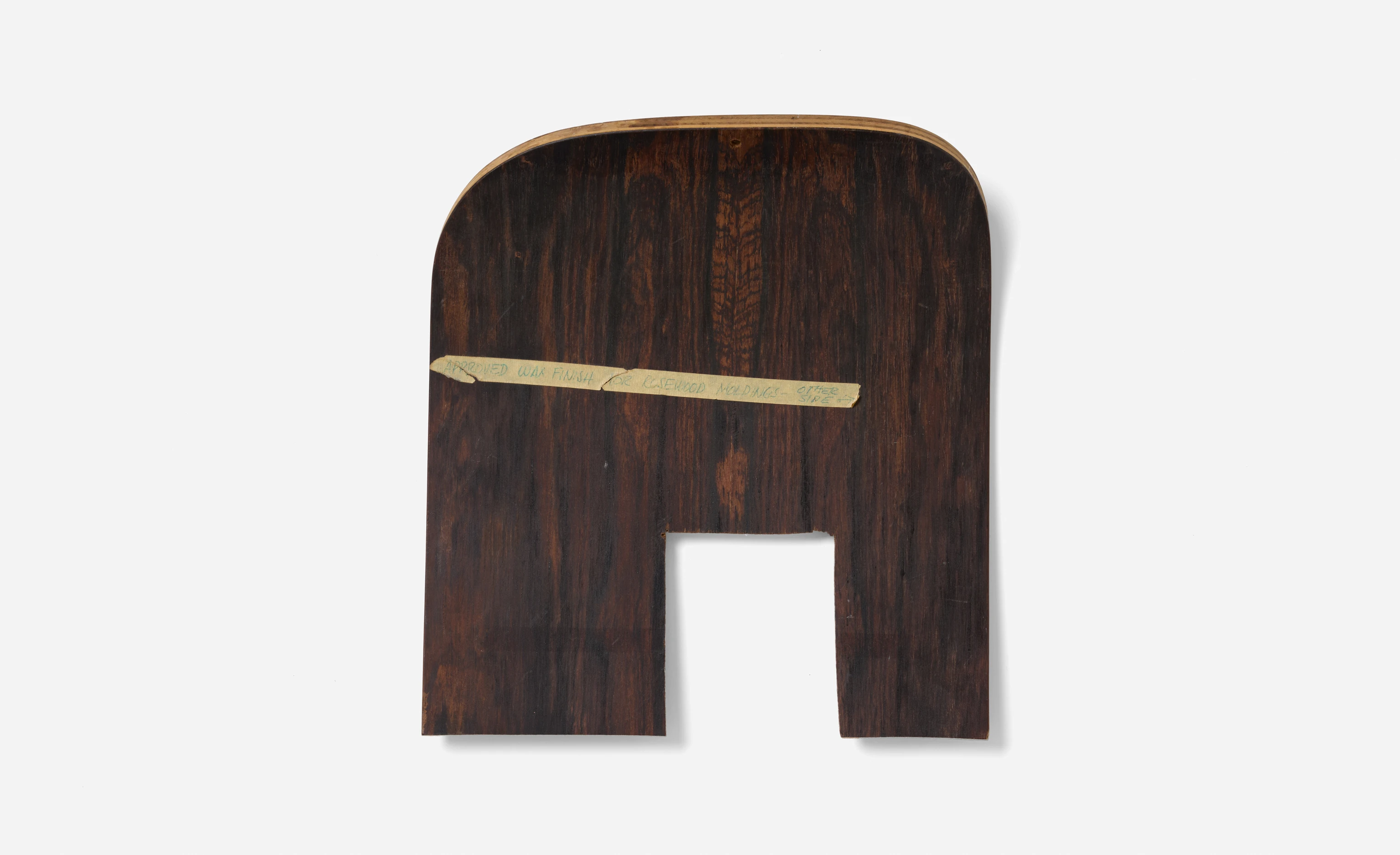 Front view of a molded rosewood sample with a note of approval to use for the Eames Lounge Chair and Ottoman.