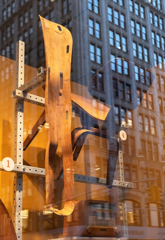 Herman Miller window display featuring Eames molded plywood designs, including an original 1942 leg splint, and an ash dining chair.
