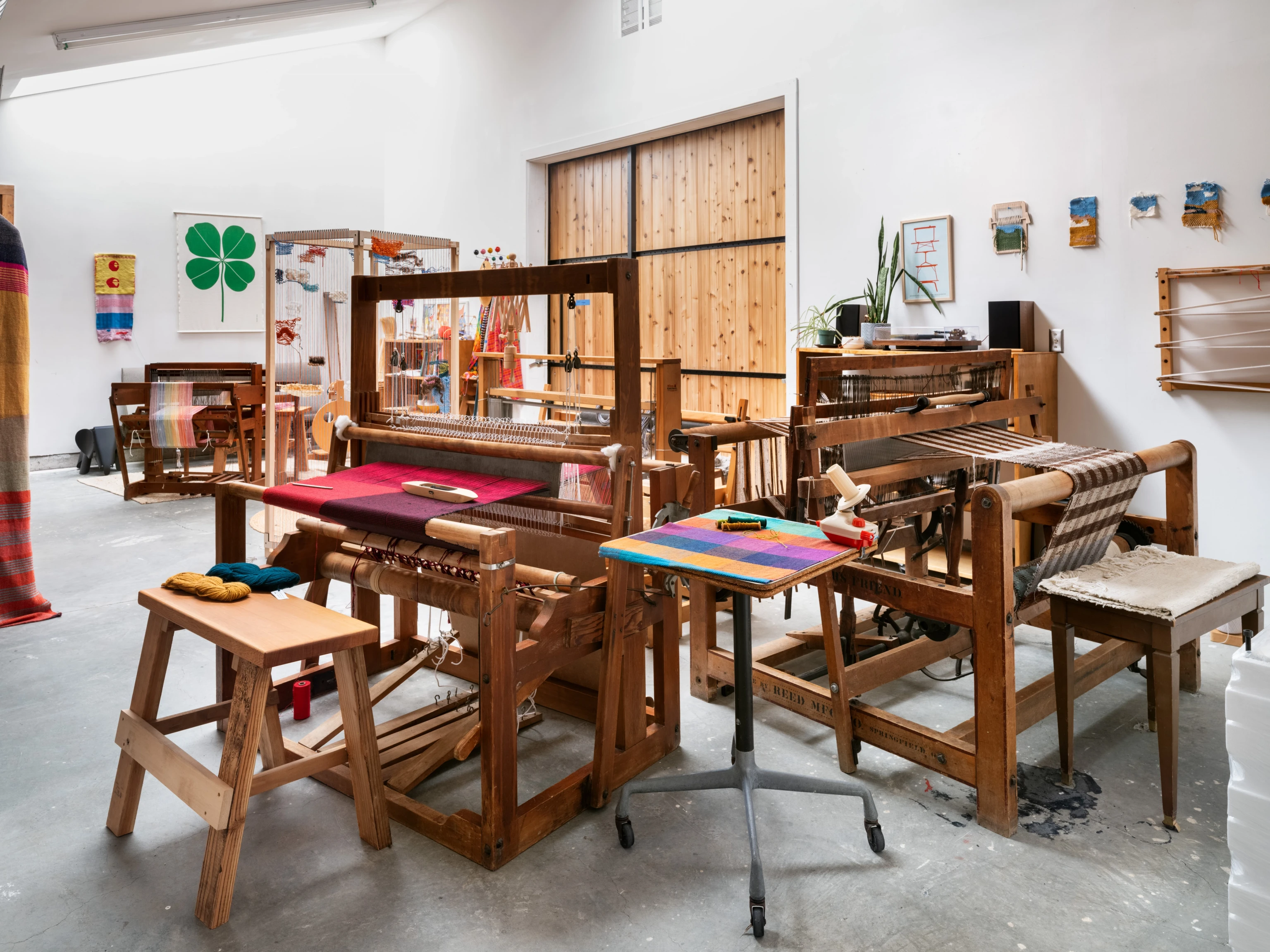 Several looms with weavings in progress at the Eames Ranch Studios workshop.