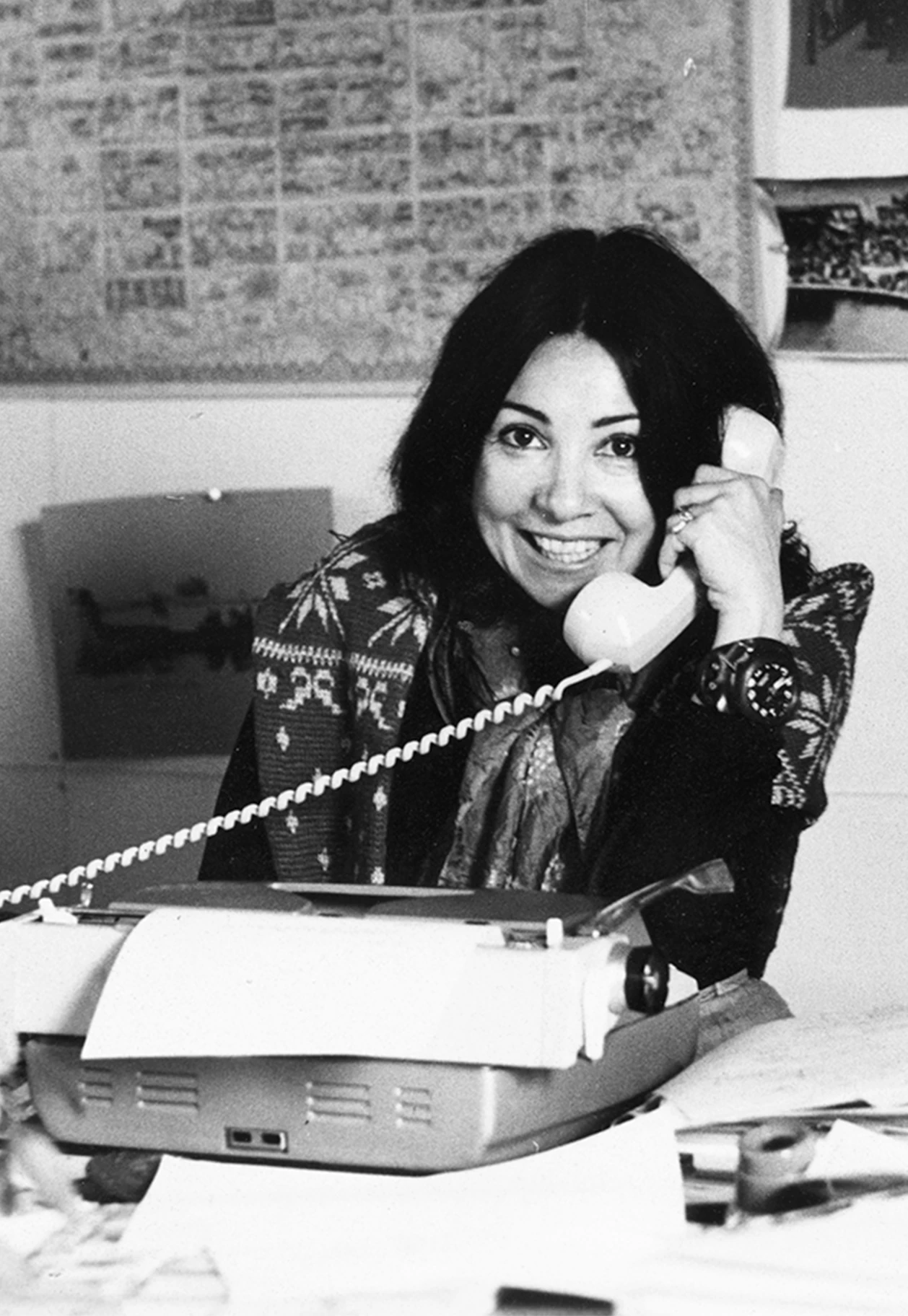 Designer Annette Del Zoppo of the Eames Office on the phone with a typewriter on her desk.