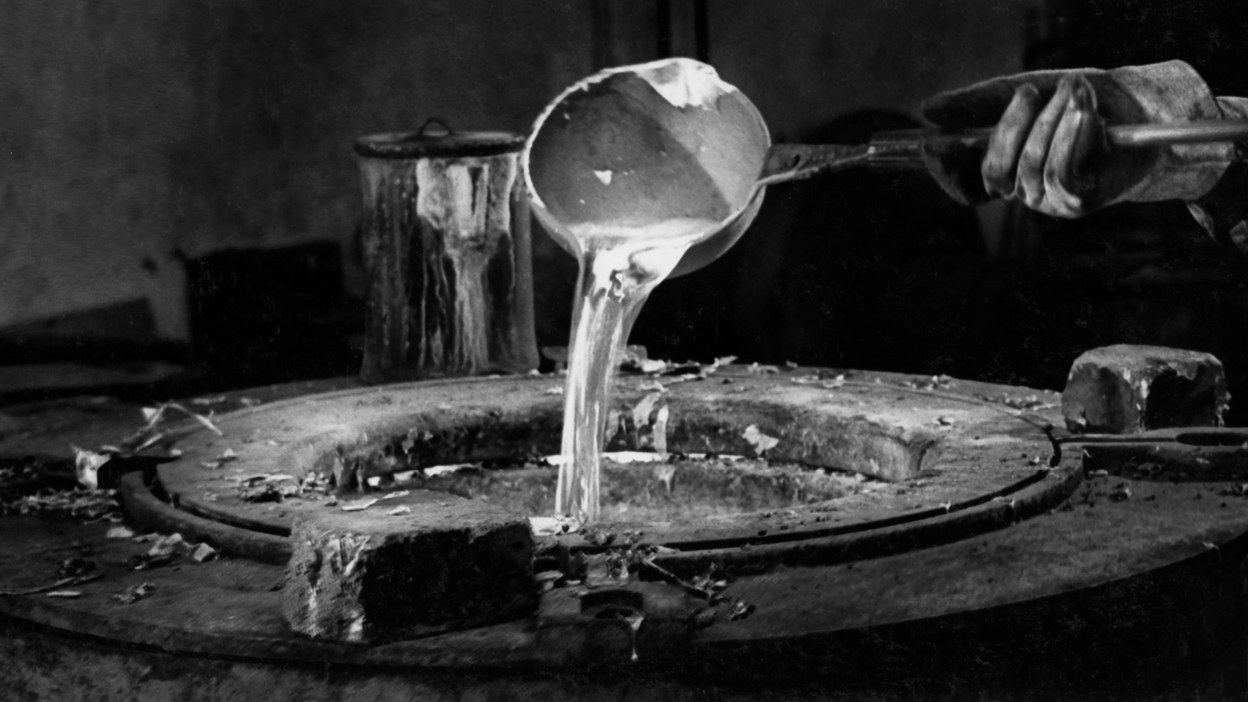 Molten aluminum is poured into a mold for Eames Aluminum Group furniture. Image courtesy of Herman Miller Archives.