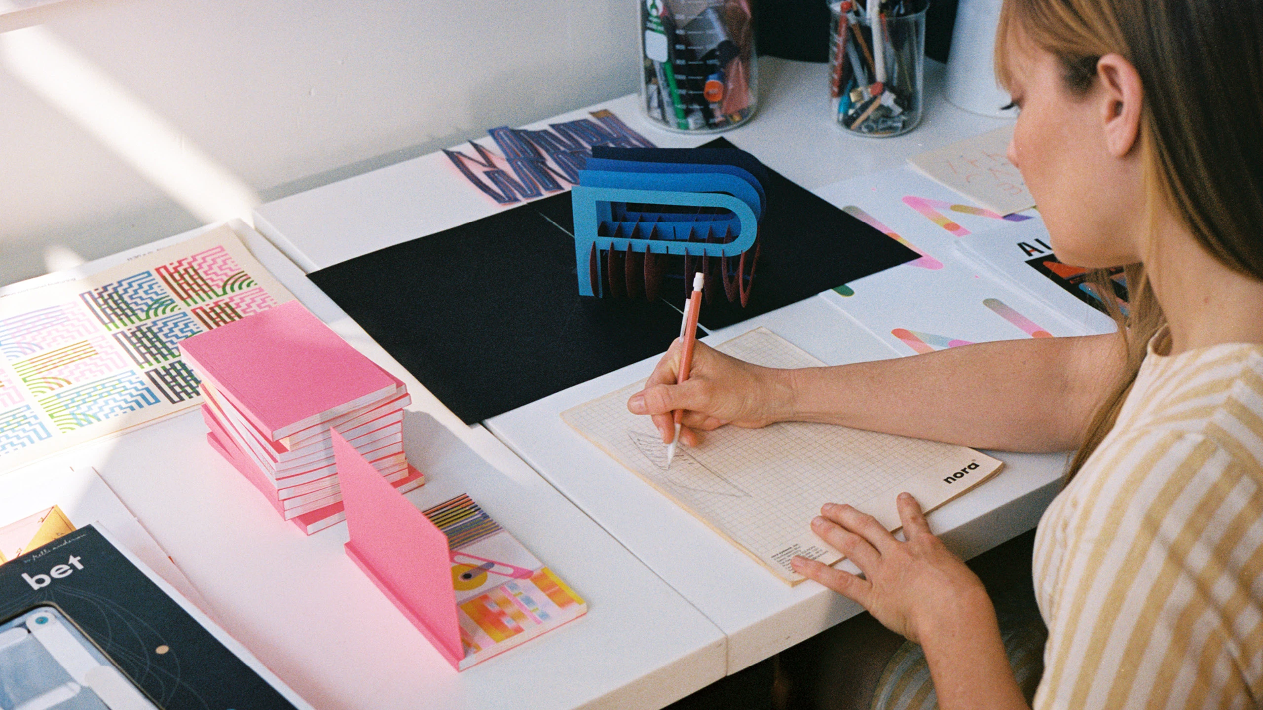 Designer Kelli Anderson working on a paper engineering prototype.