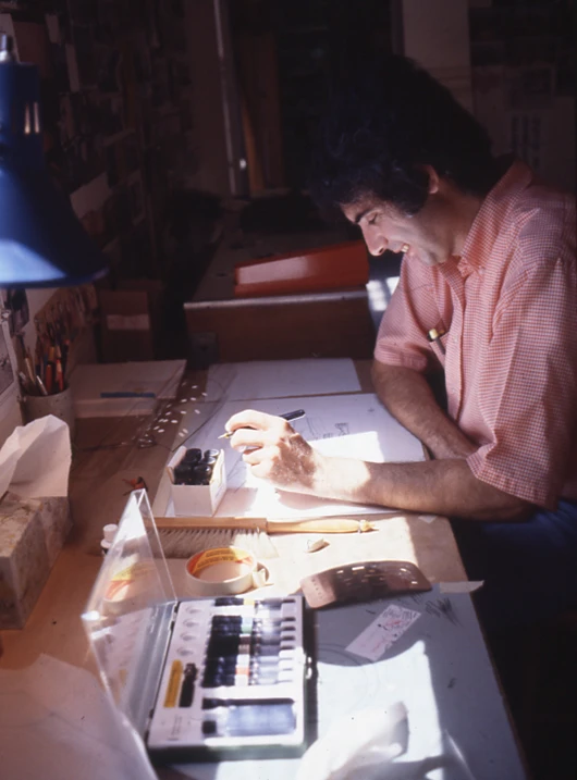 Sam Passalacqua, an industrial designer for the Eames Office, working at his desk.