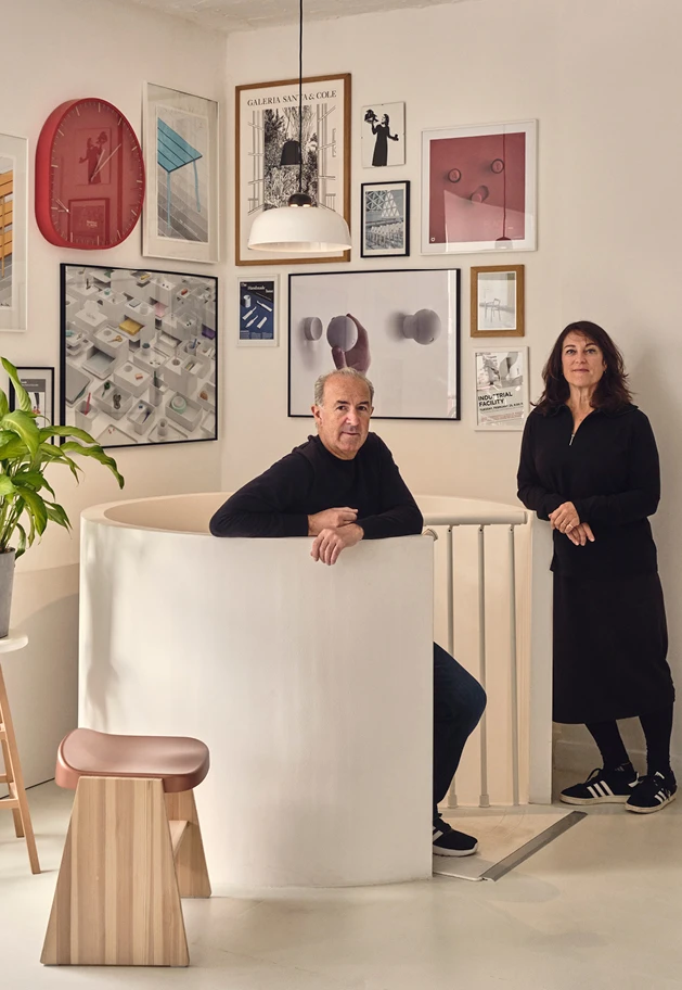 Designers Sam Hecht and Kim Colin of Industrial Facility in their studio surrounded by posters of their work—Kazam! Magazine.