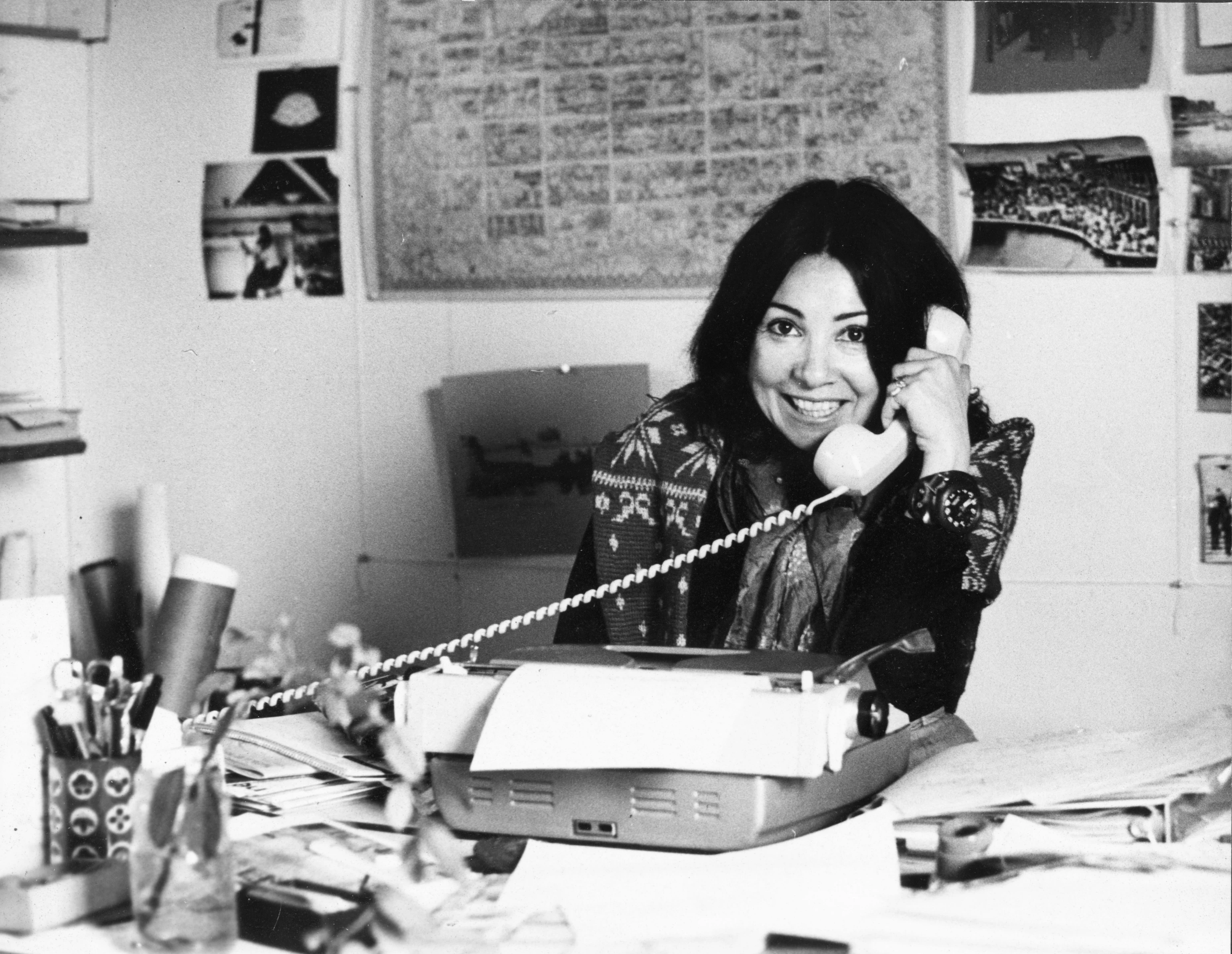 Annette Del Zoppo of the Eames Office on the phone with a typewriter on her desk.
