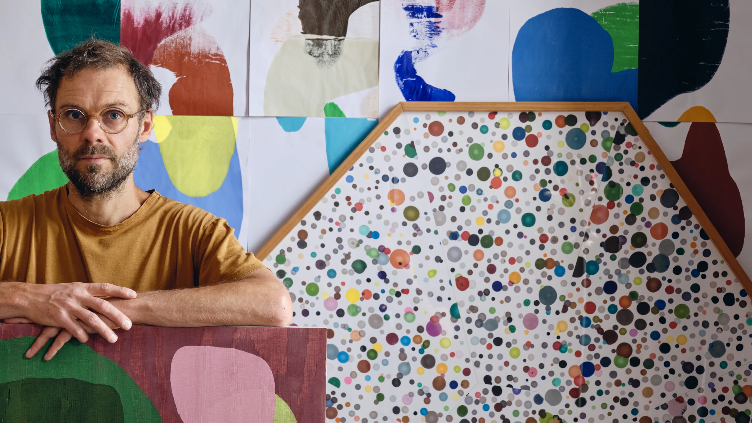 Artist Daniel Eatock in his London art studio with his work, including Assembled Rolled Forms and a framed Felt-Tip Print.
