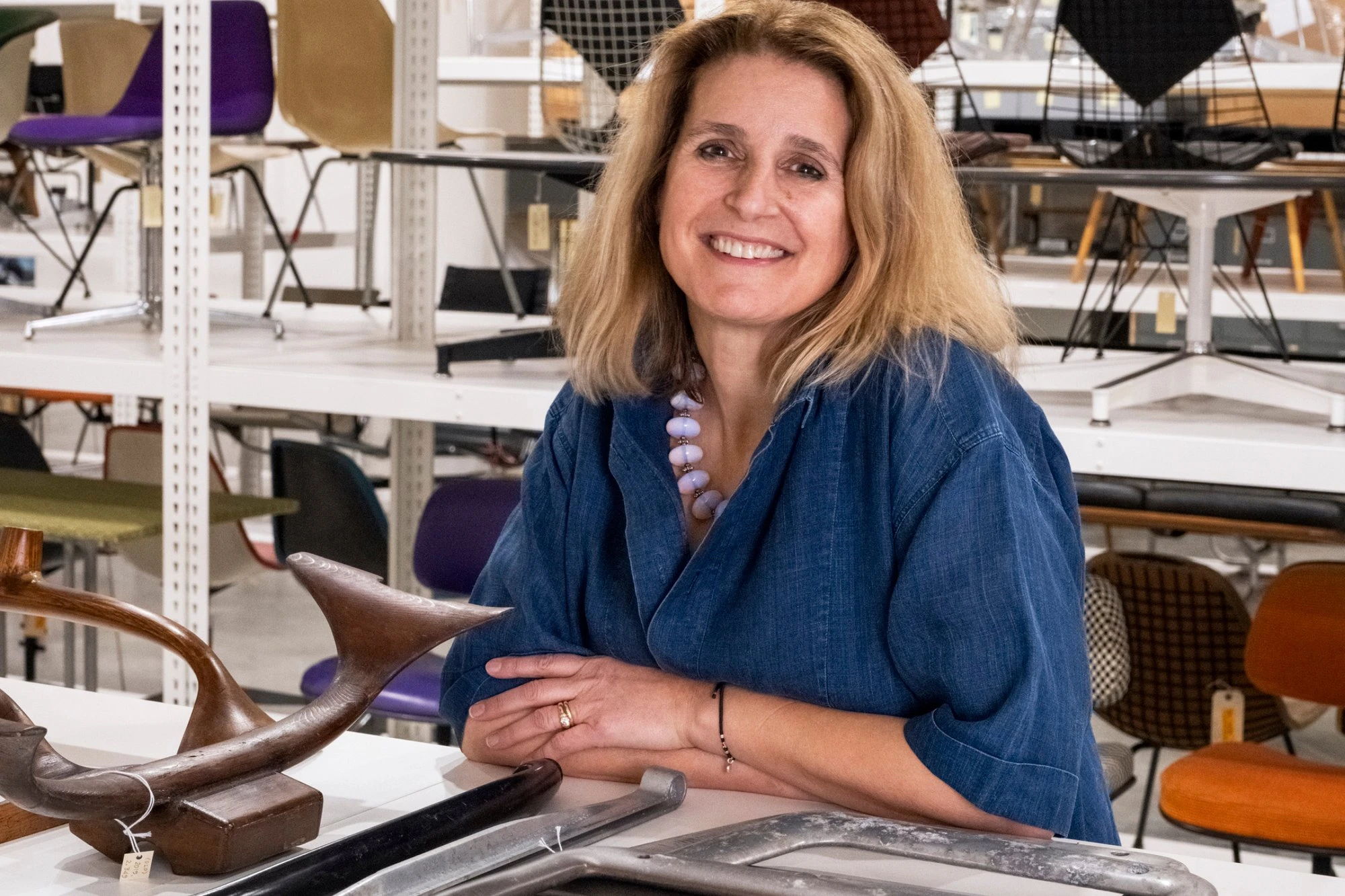 Llisa Demetrios, chief curator of the Eames Institute sitting among the Eameses' many designs.