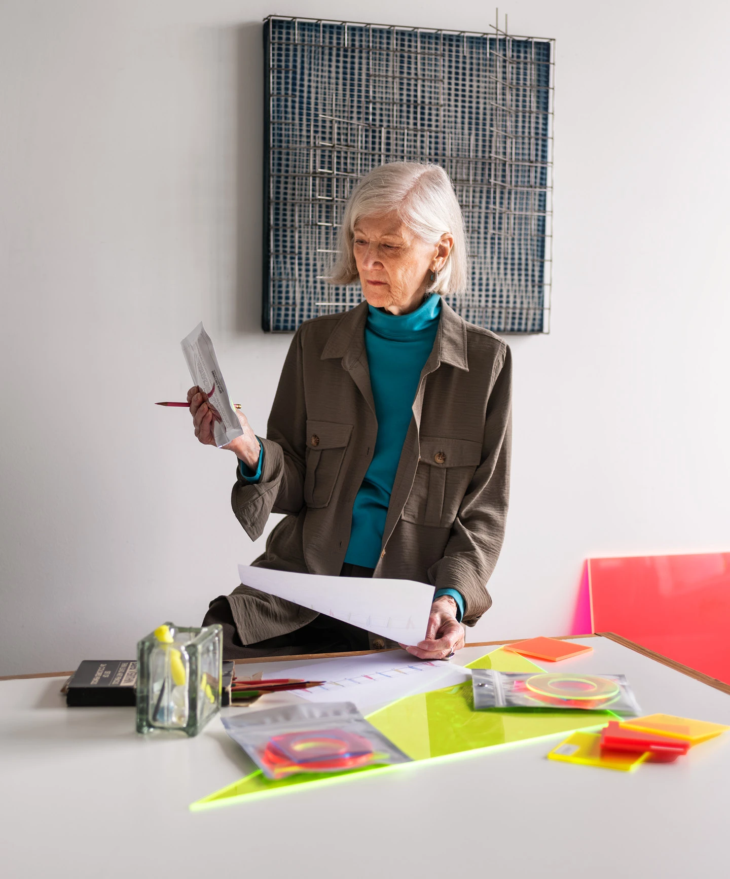 Artist Barbara Kasten working in her studio with SHIELD XXIII (2022) in the background.