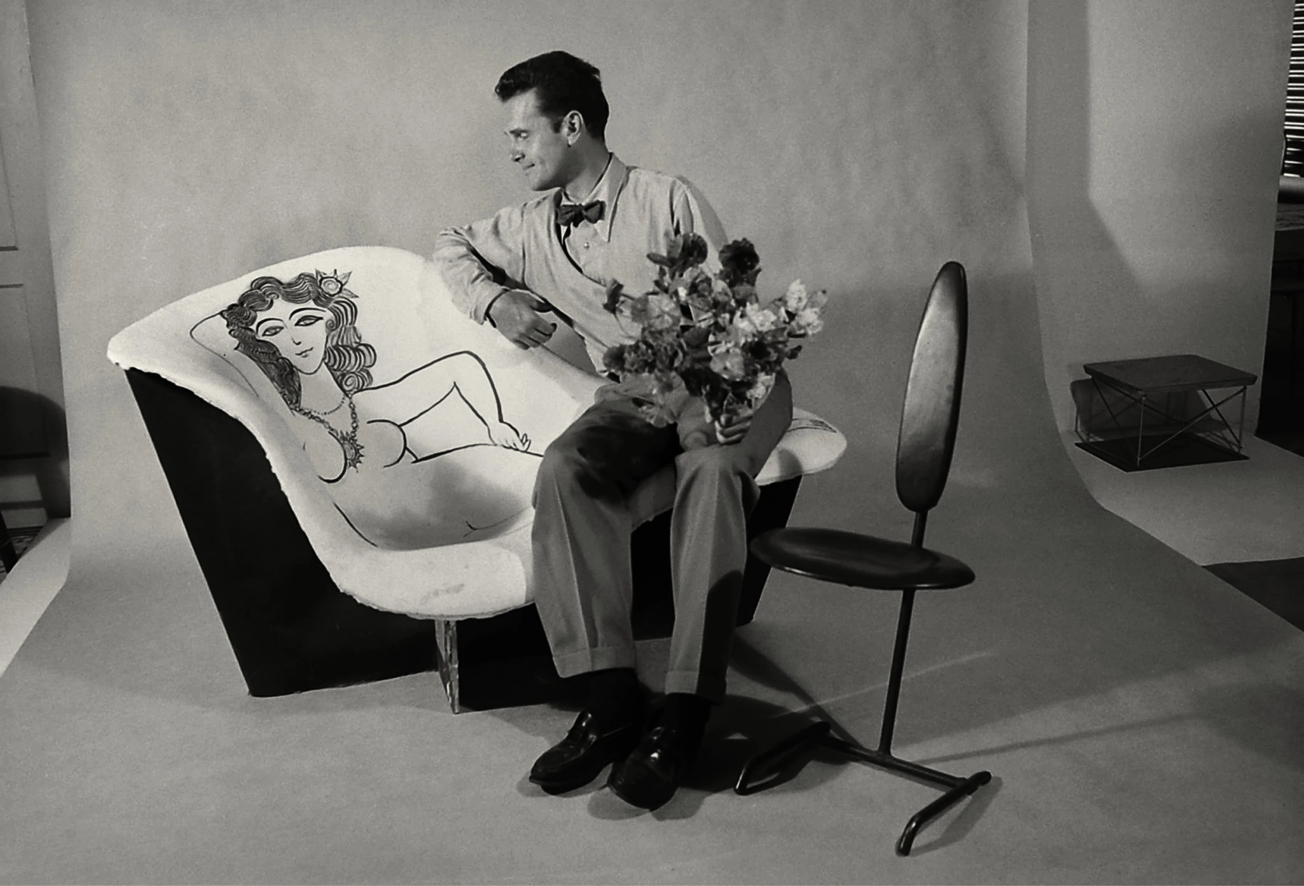 Charles Eames on a La Chaise mold painted with a Steinberg nude. Peter Stackpole/The LIFE Picture Collection/Shutterstock.