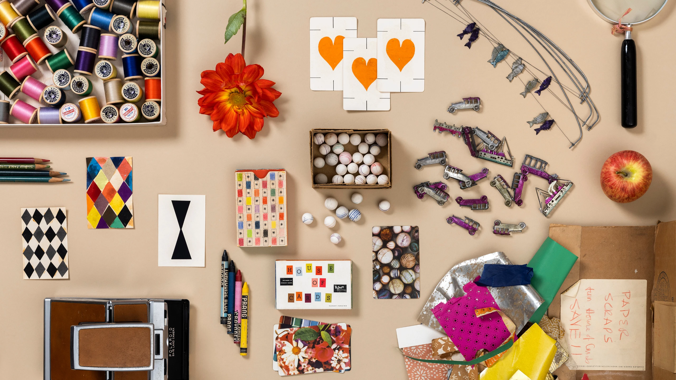 Eames House of Cards mock-ups created by artist and designer Ray Eames along with some tools and ephemera.