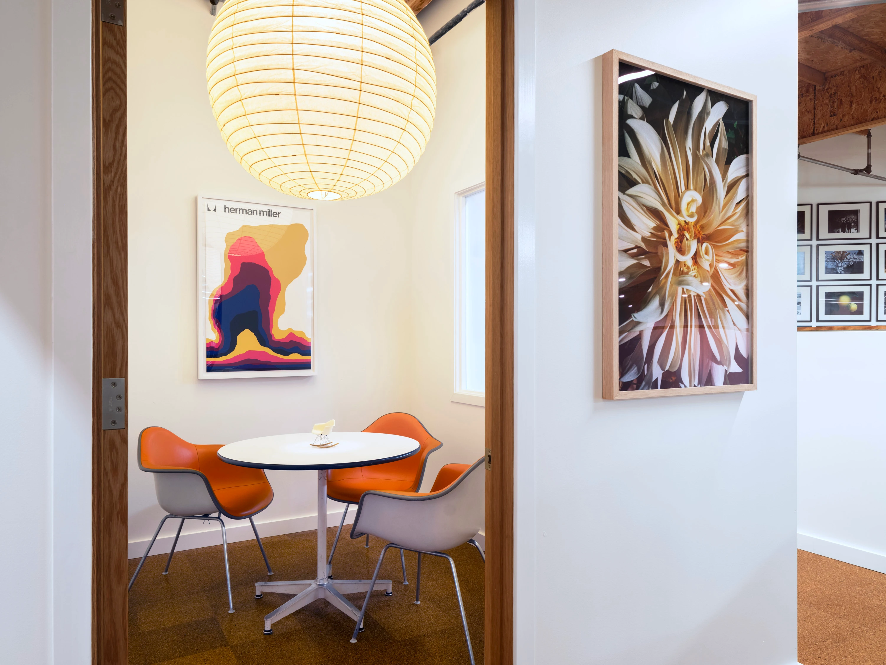 A small meeting room with a large paper lantern at the Eames Institute's Richmond offices.