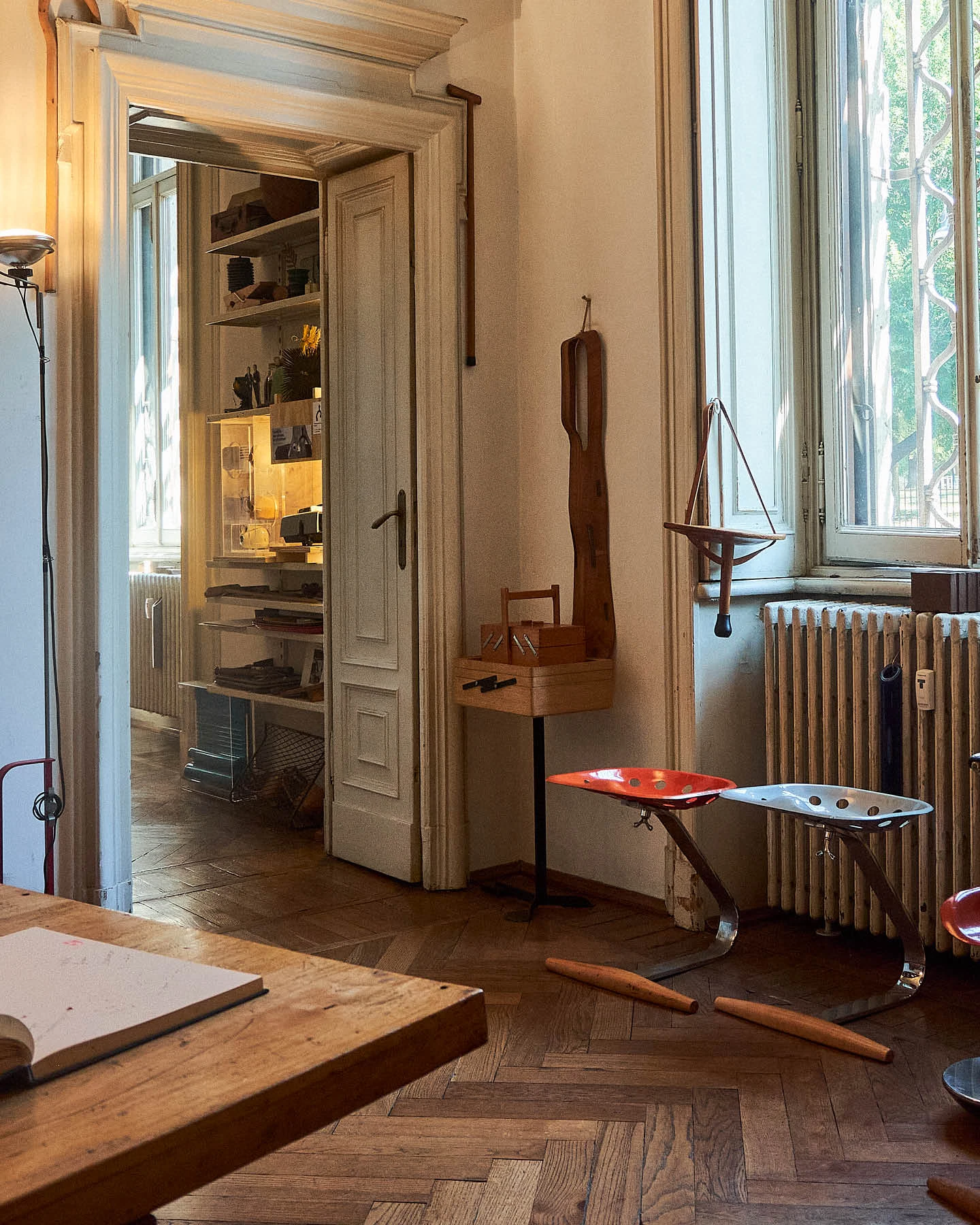 A pair of Mezzadro stools designed by Achille Castiglioni displayed in his Milan design studio.