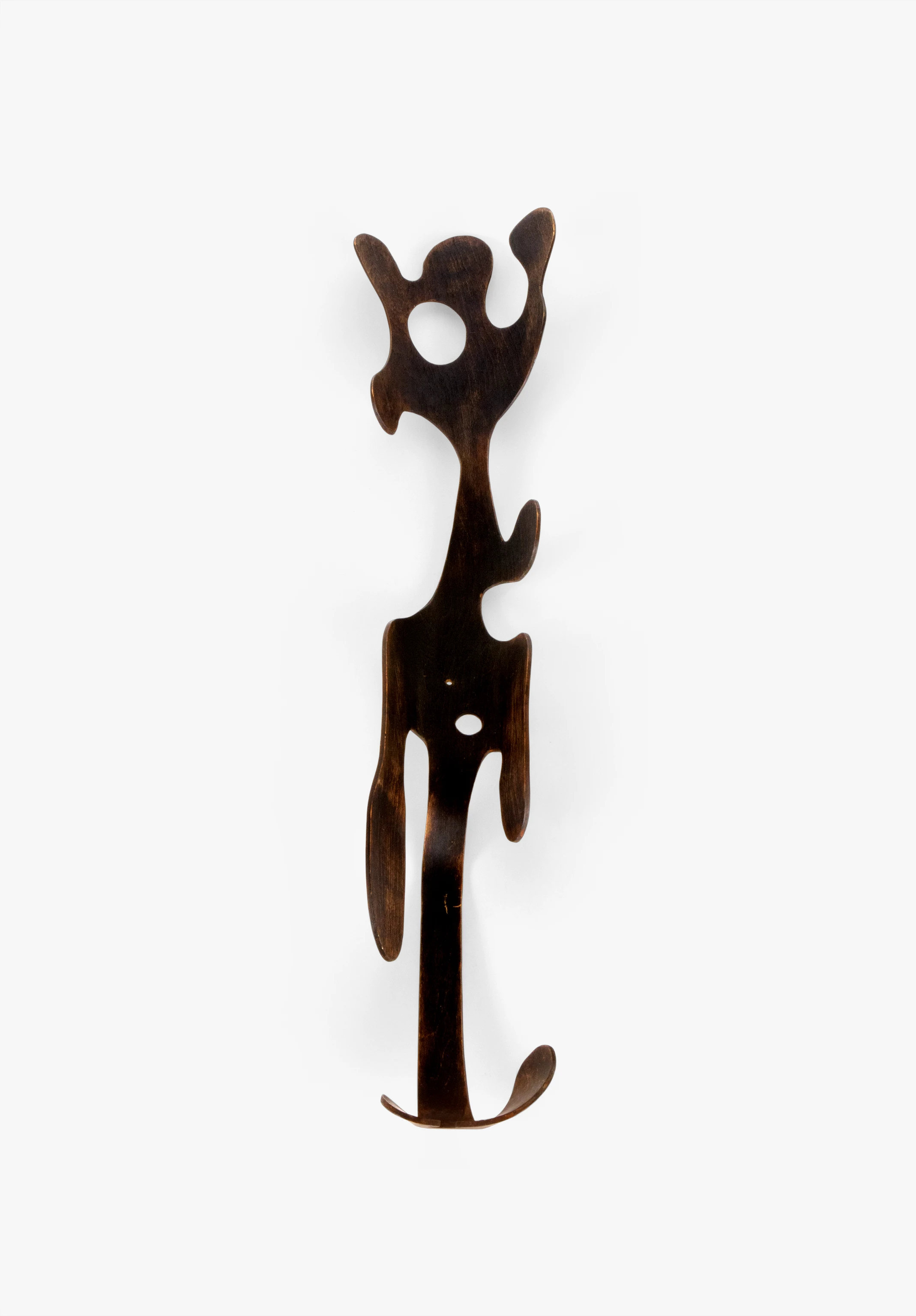 Front view of a sculpture designed by Ray Eames cut from a birch plywood splint and stained with black aniline dye.