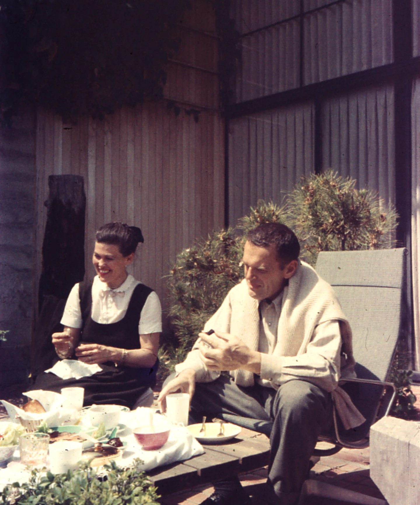Ray and Charles Eames sitting on the patio at Case Study House 8.