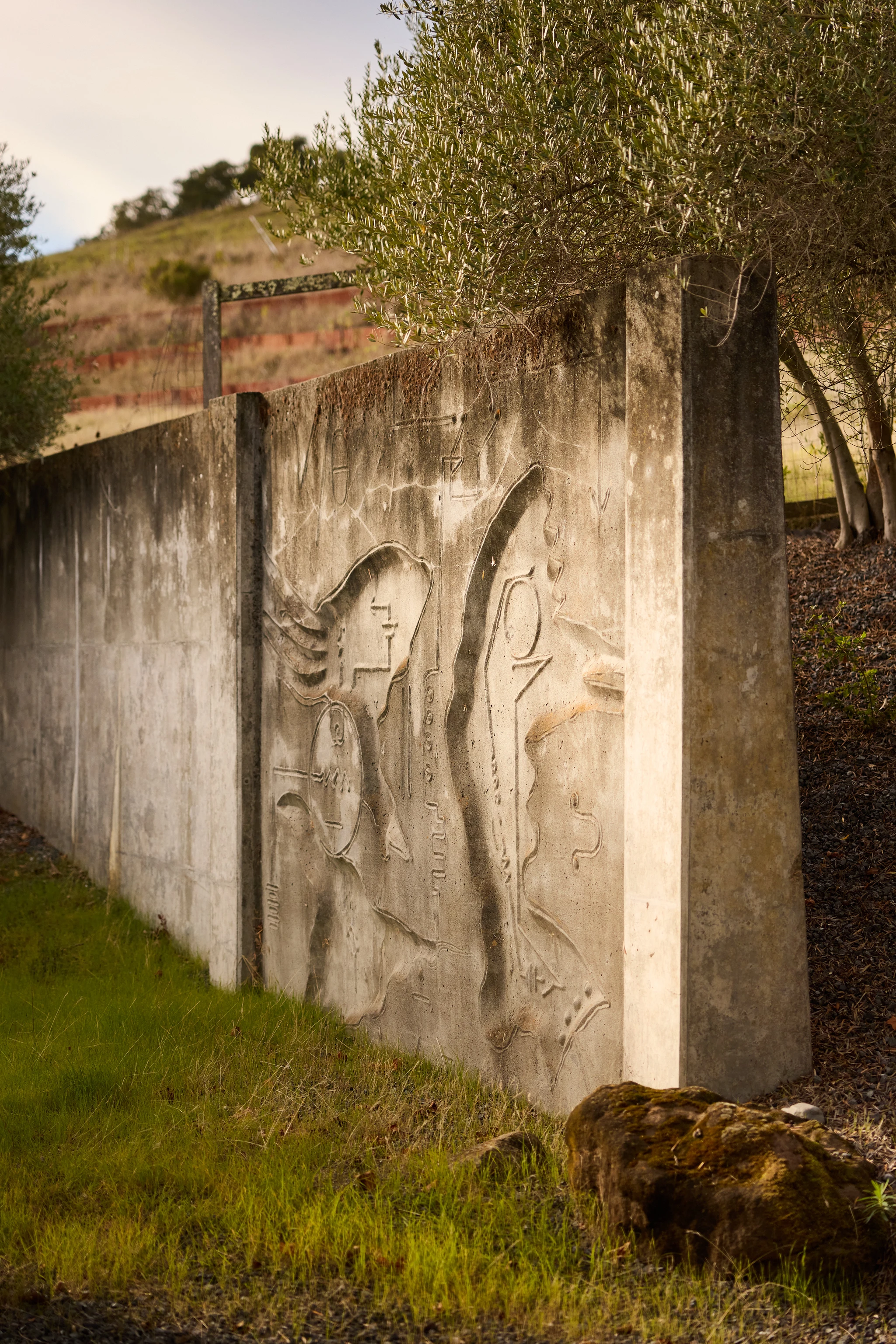 Cropped view of a carved concrete relief mural by artist Gurdon Woods.