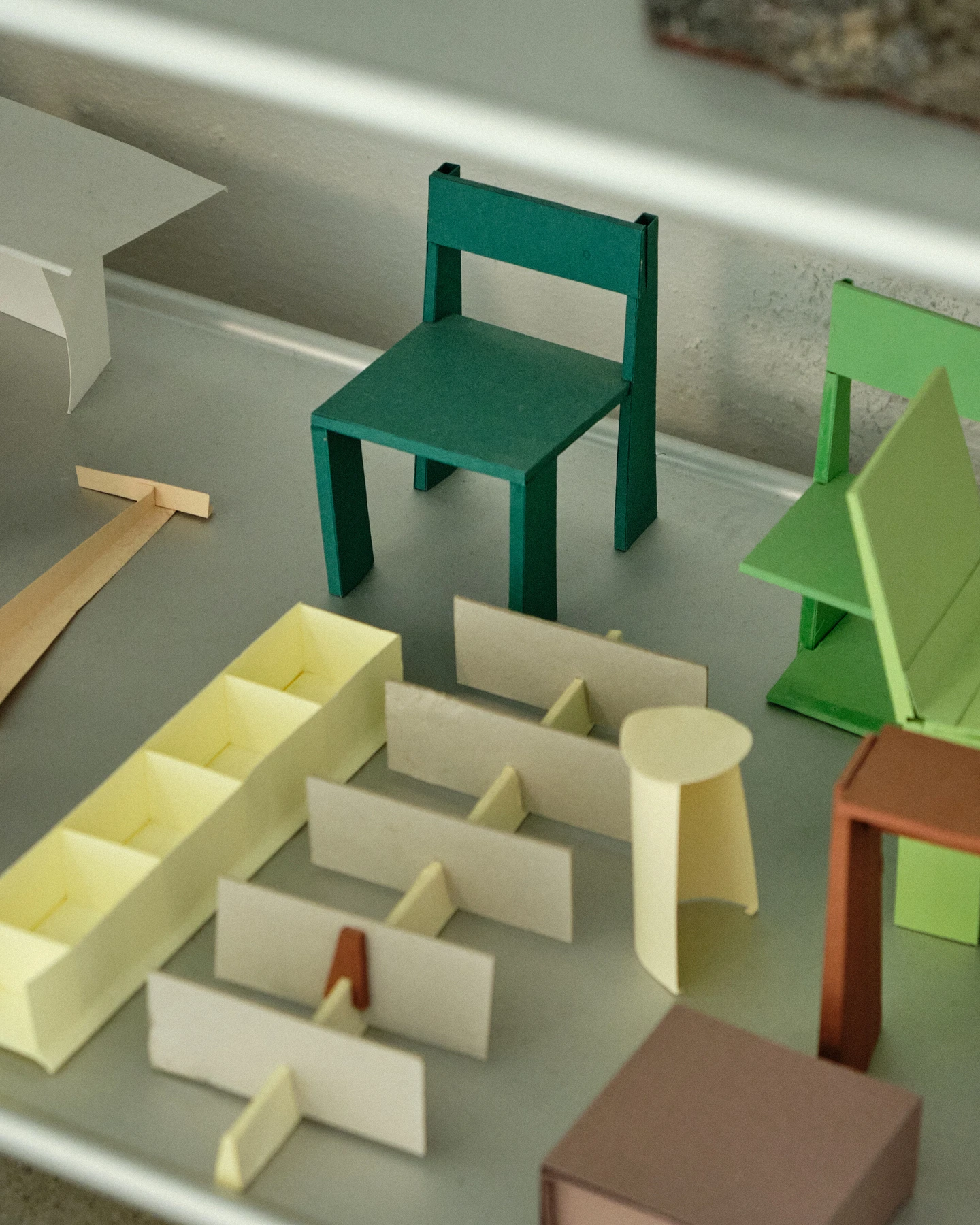 Several wood and paper furniture prototypes in bright colors, from design studio Formafantasma.