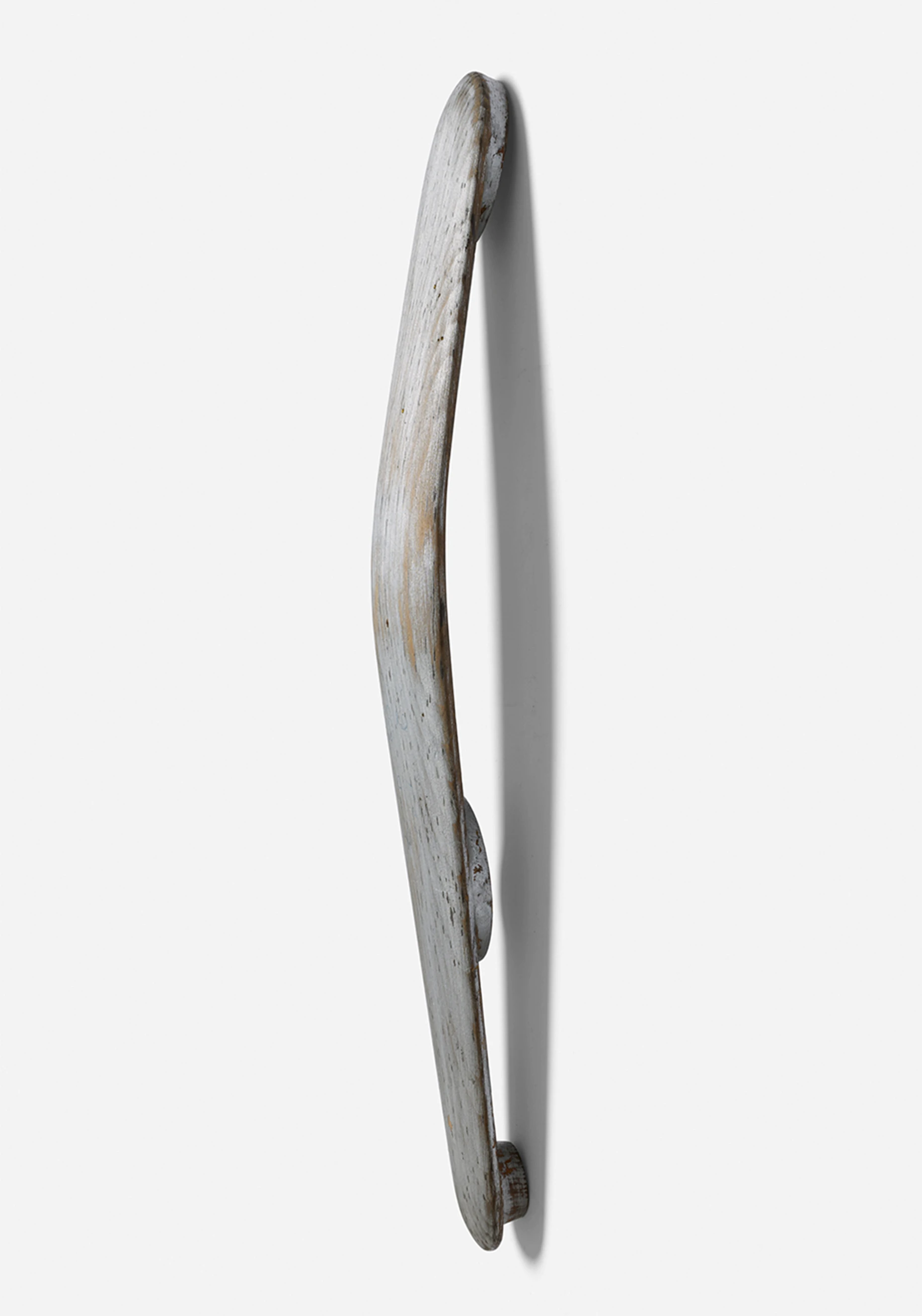 Side view of a carved and painted wooden model for the aluminum back support of the Eames Lounge Chair.