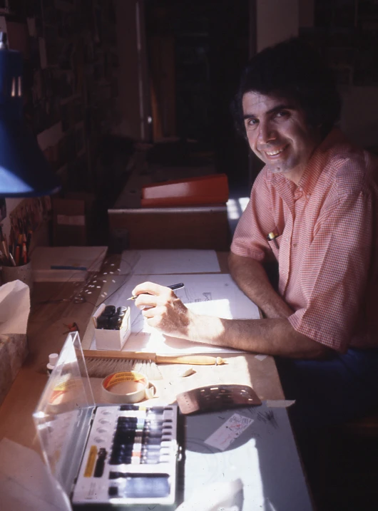 Industrial designer Sam Passalacqua drawing at his desk at the Eames Office.