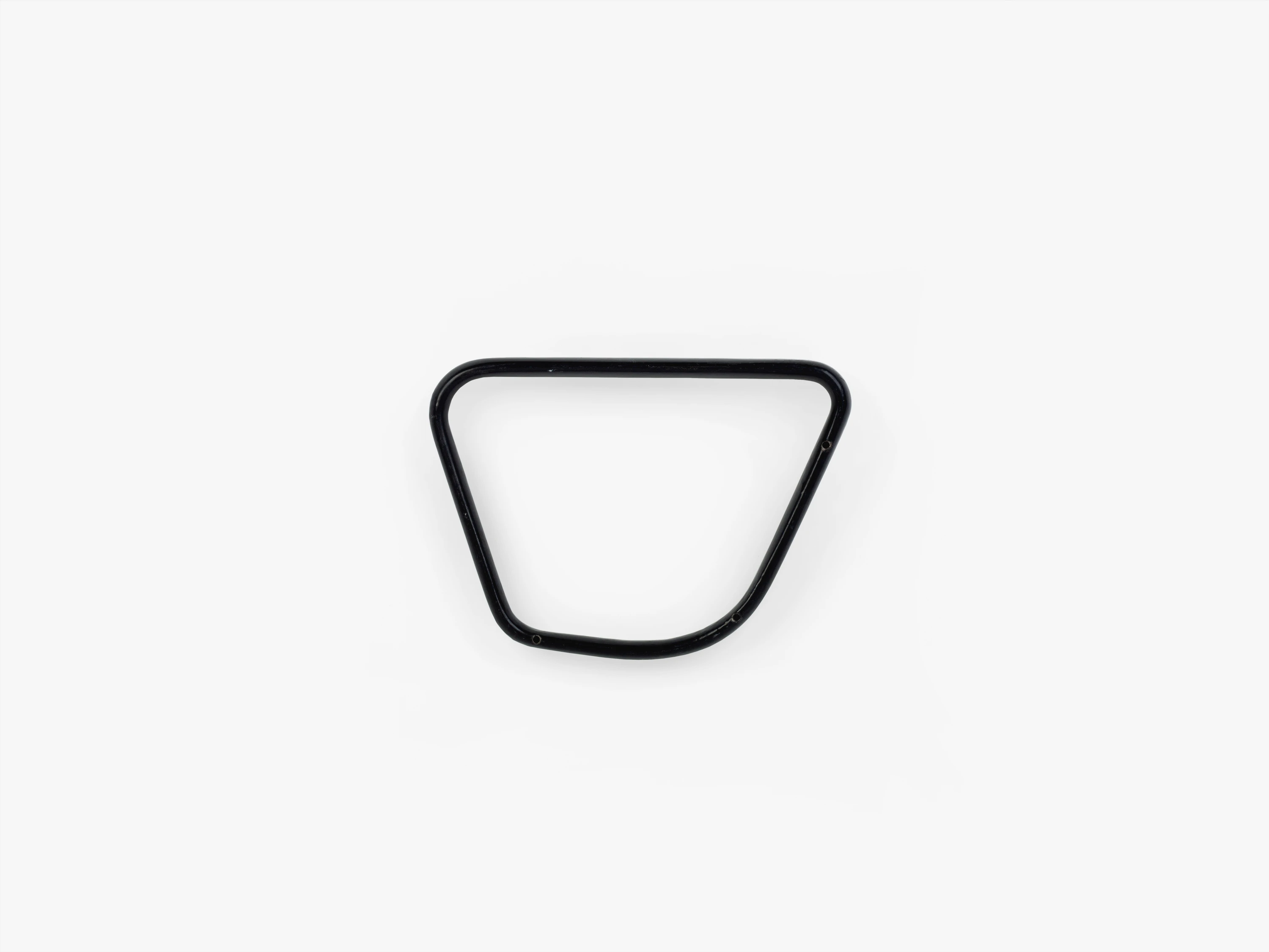 Side view of an Eames Aluminum Group charcoal nylon-coated aluminum armrest in a trapezoid shape with rounded corners.