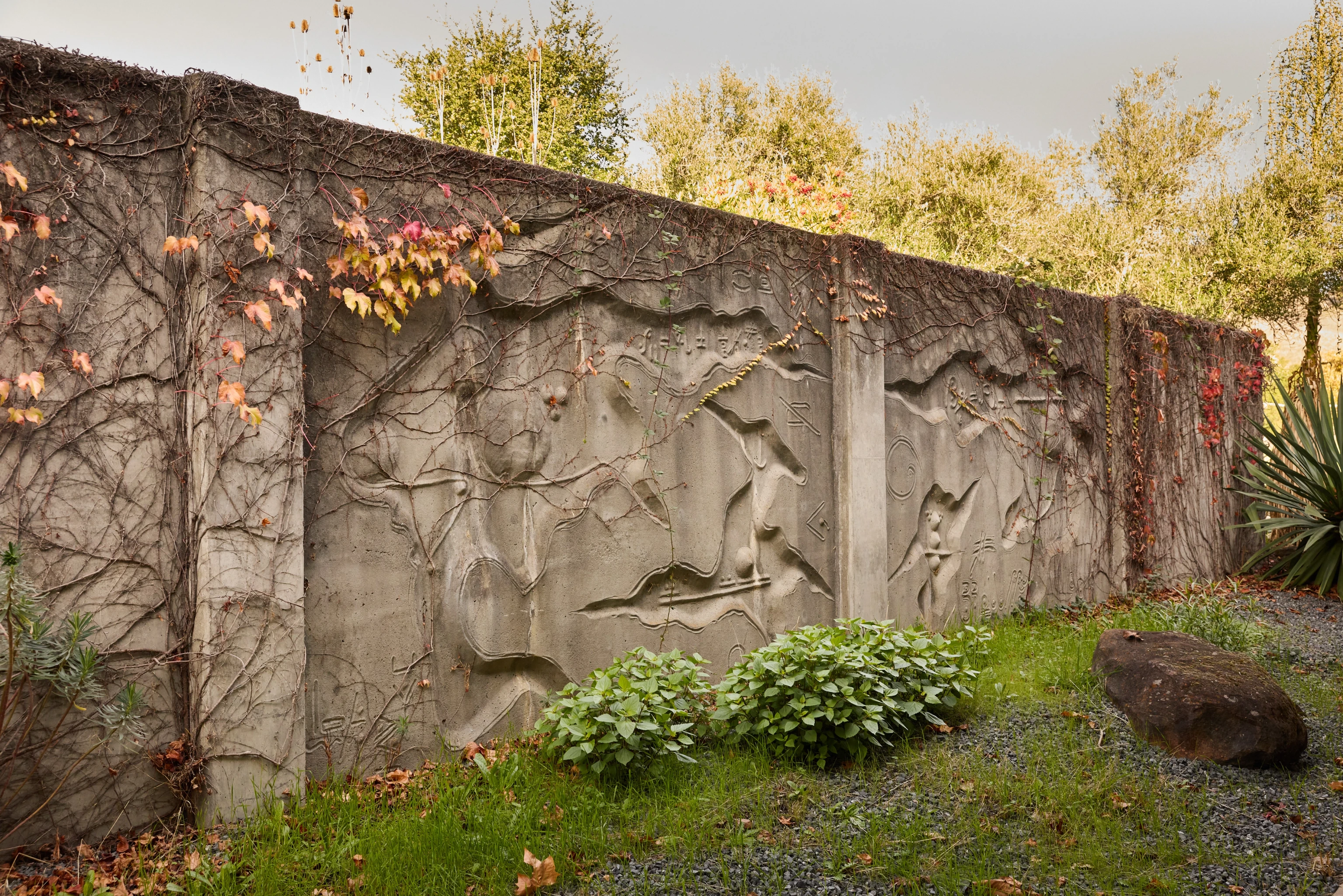 Angled view of a concrete relief mural by artist Gurdon Woods.