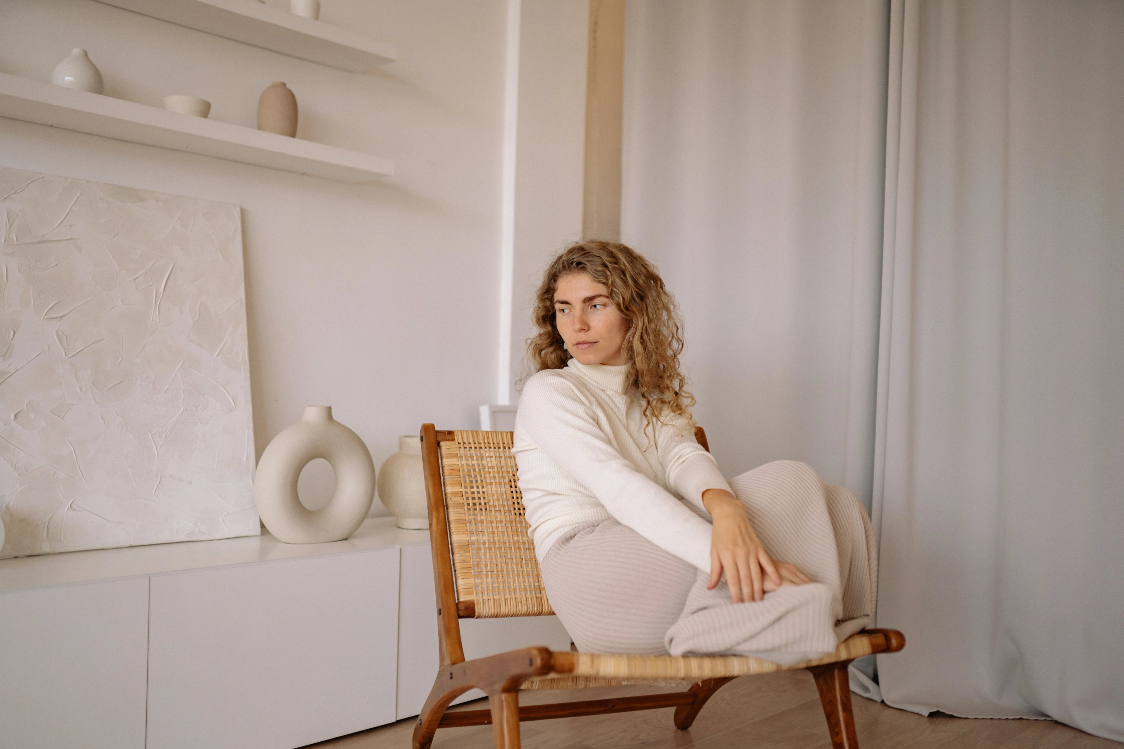 Woman sitting in a chair in soft natural light