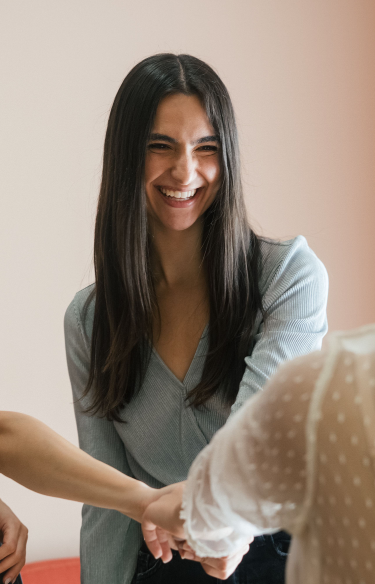 Two women talking together in a bright room