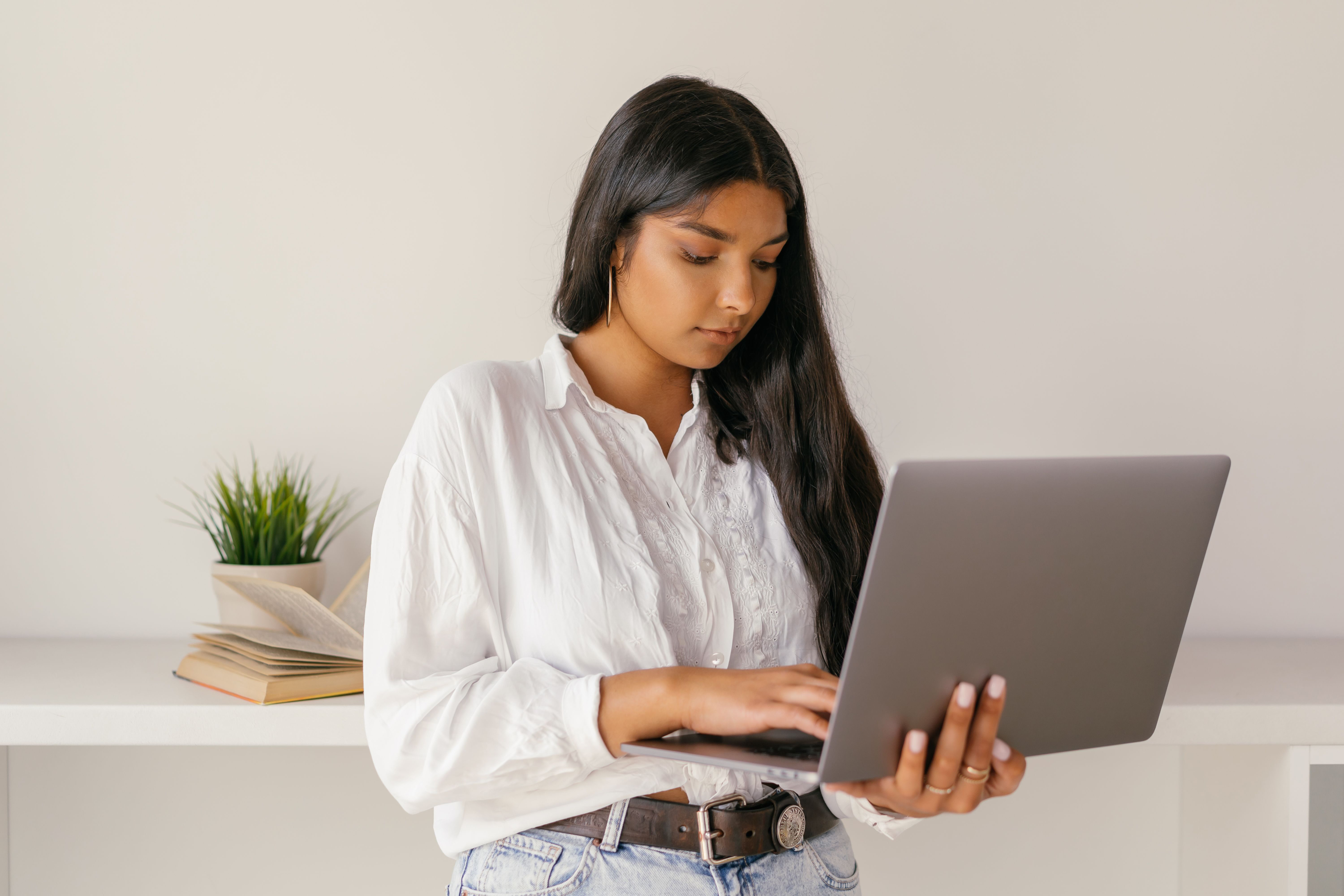 Woman reviewing documents on a laptop