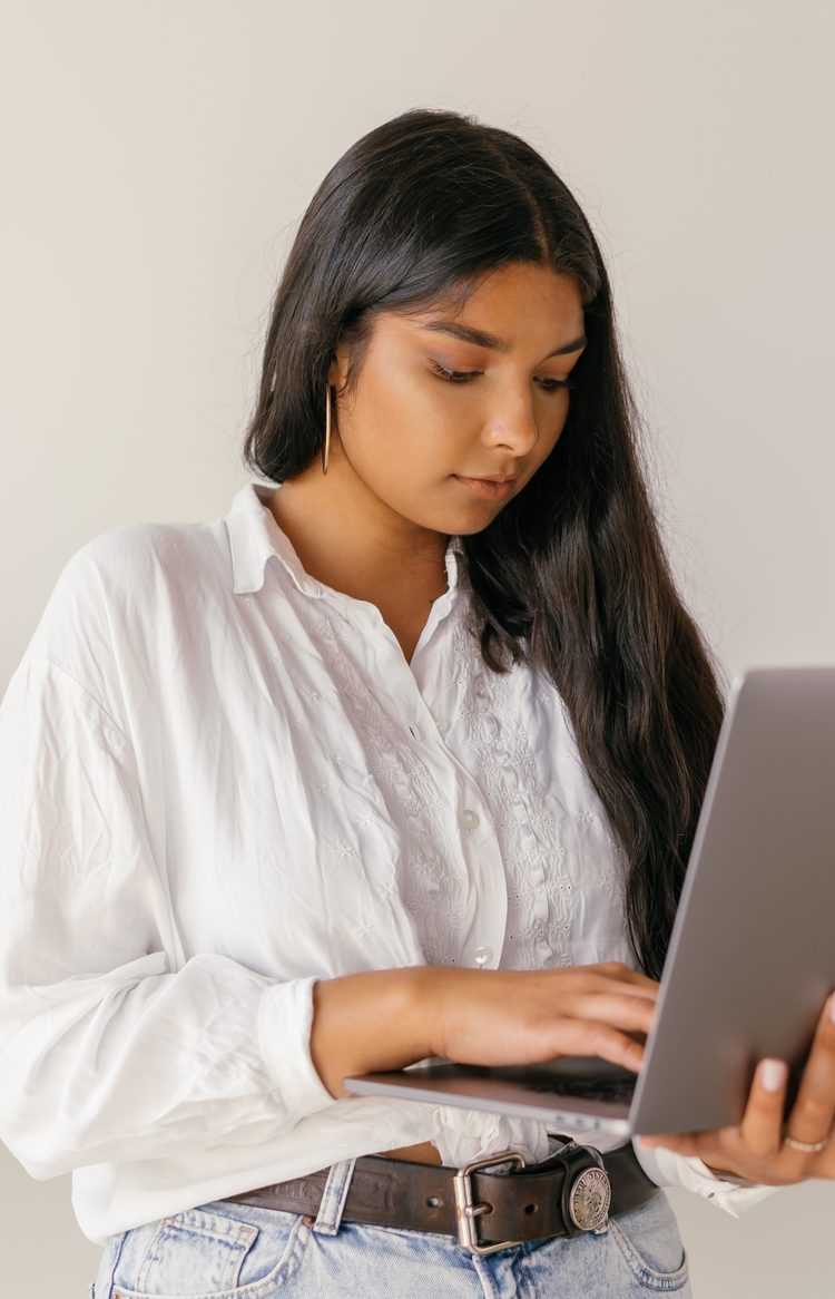 Woman reviewing documents on a laptop