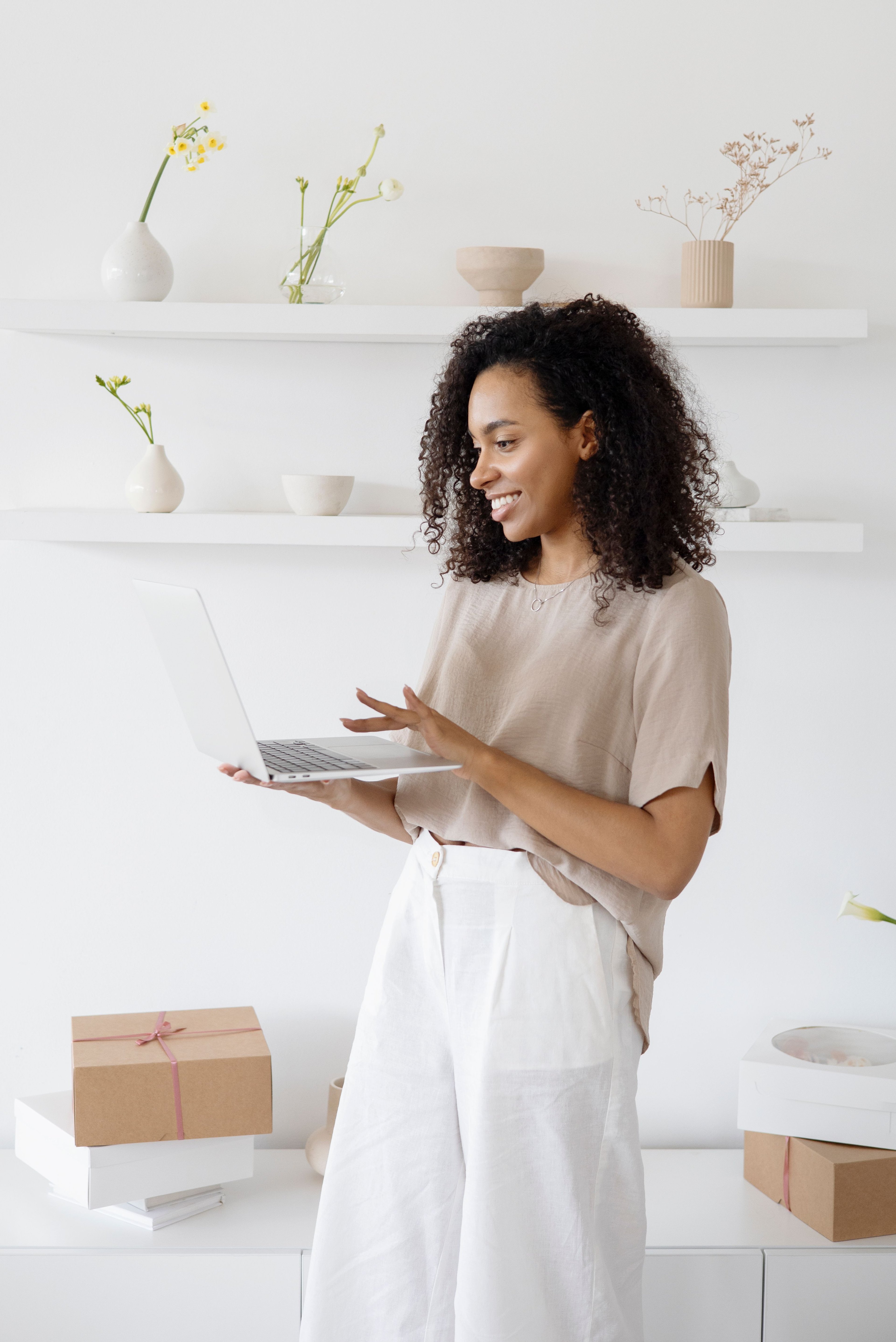 Woman working on a laptop in an airy room