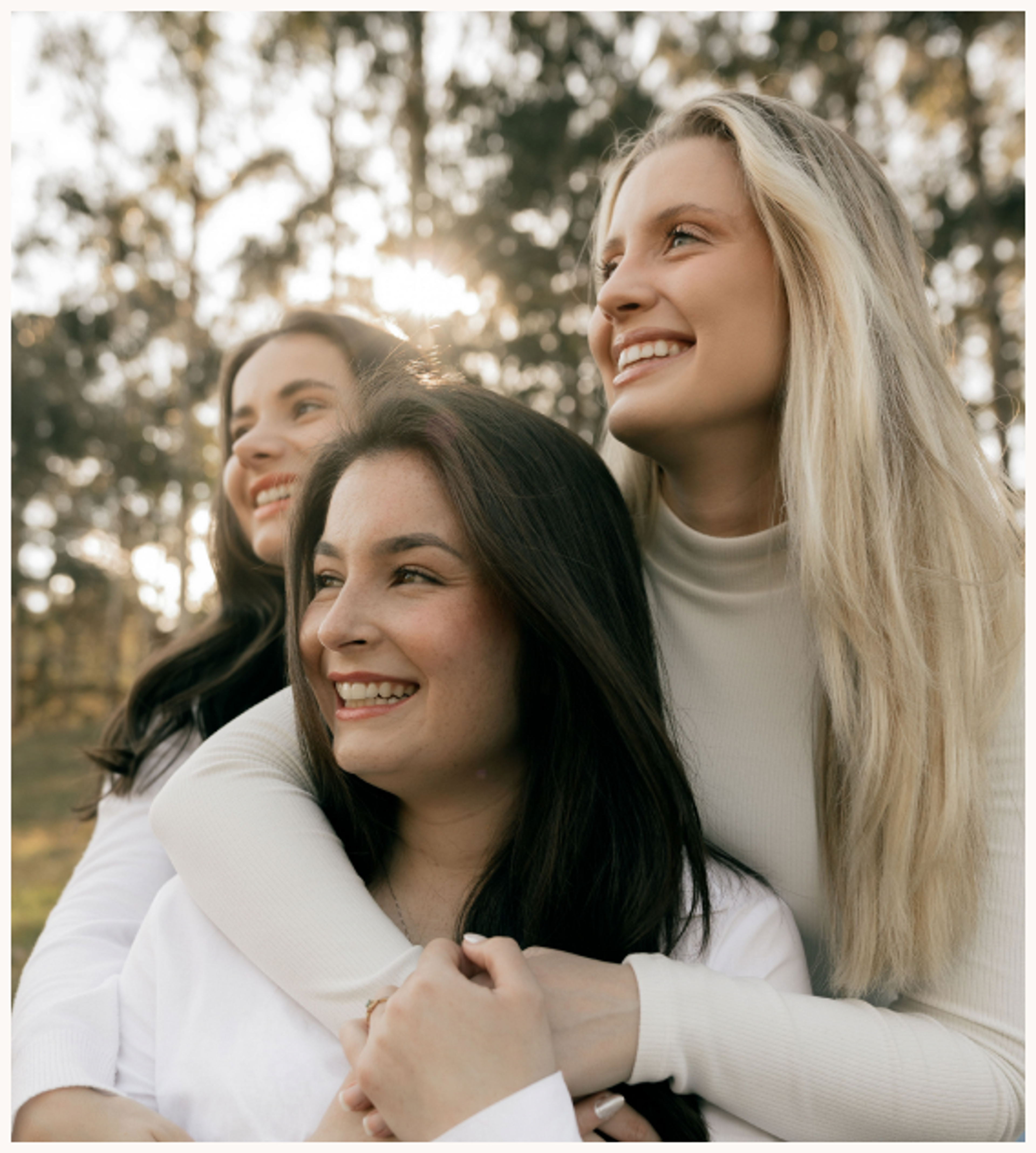 Three women smiling outdoors