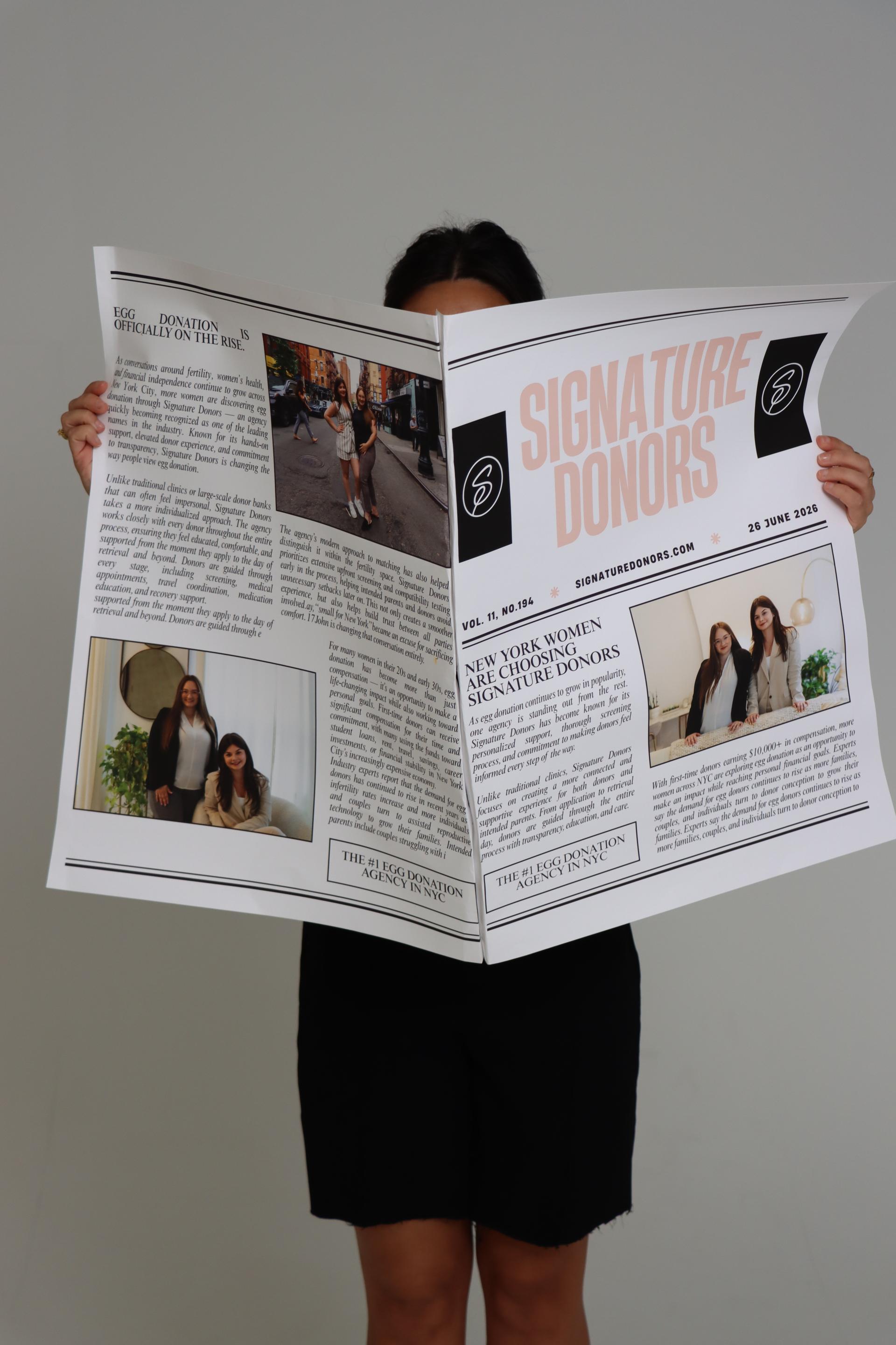 Person holding an open newspaper