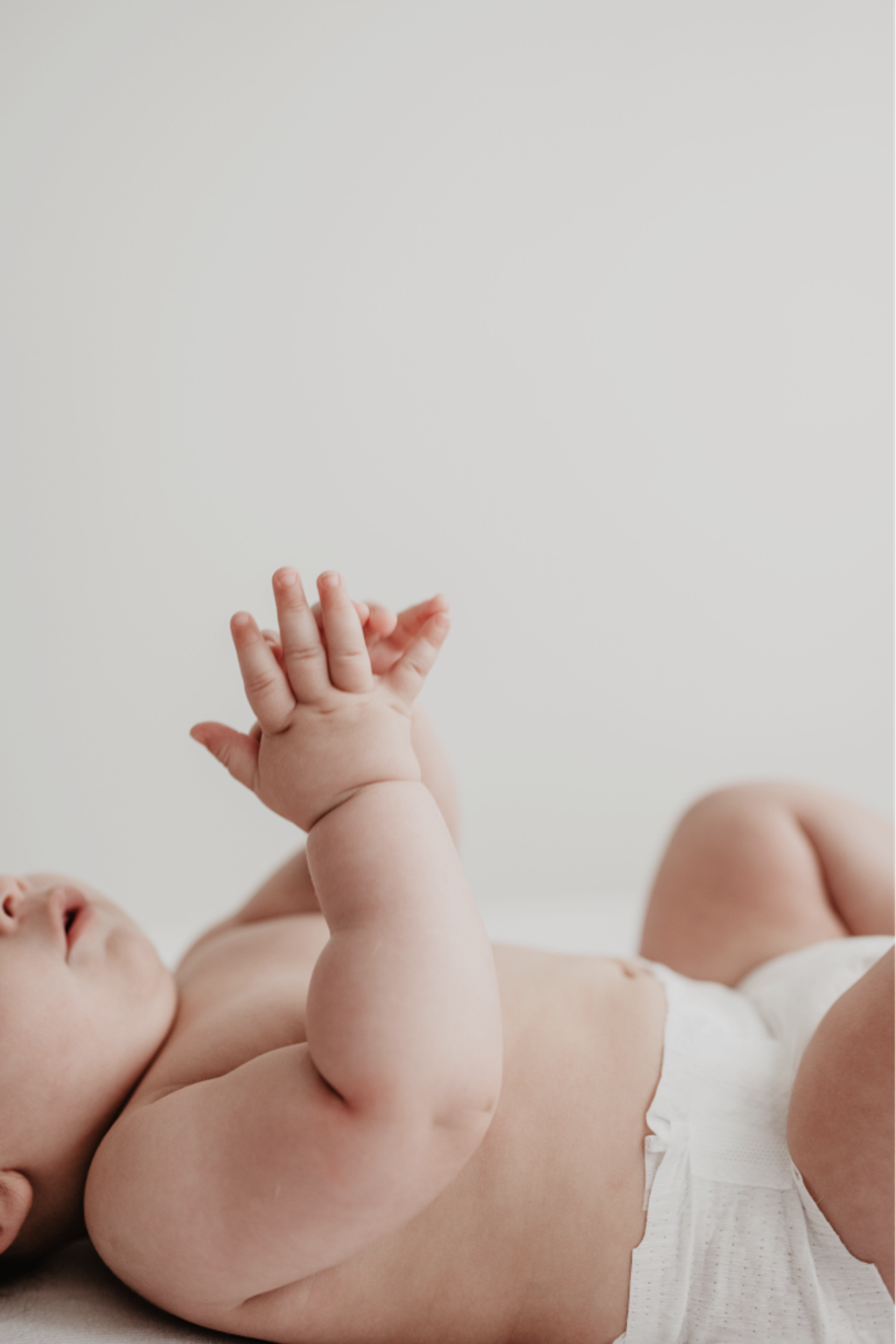 Baby reaching upward outdoors